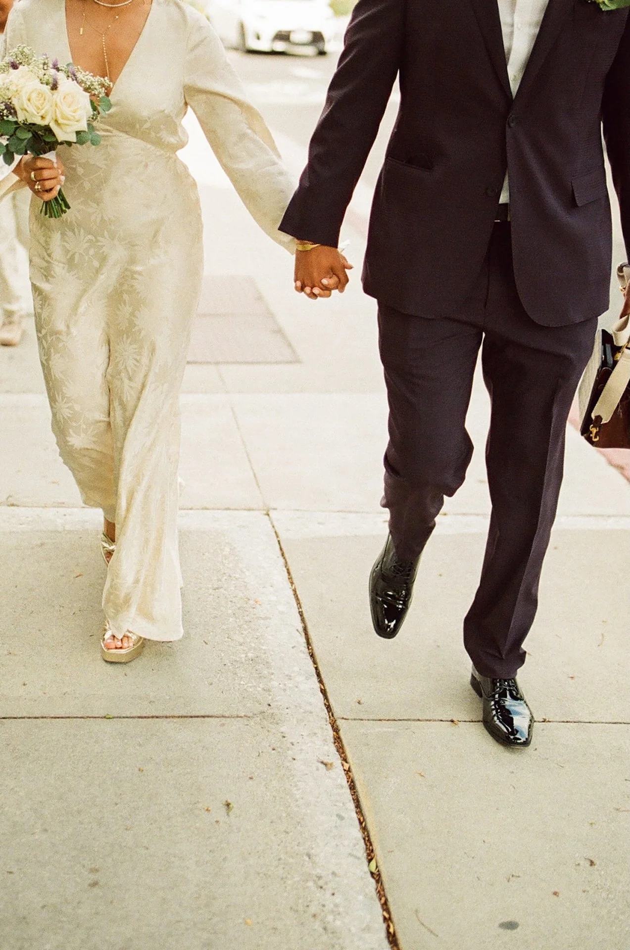 Detail photo of the bride and groom walking along the sidewalk after their Beverly Hills Courthouse Elopement