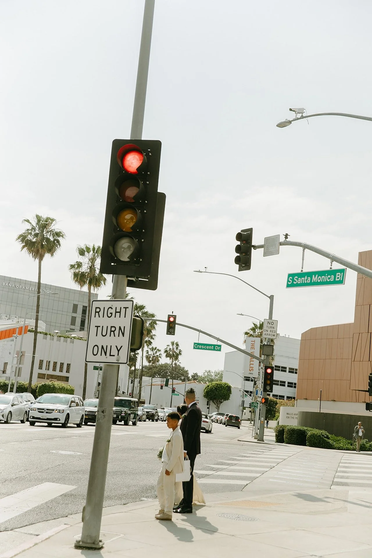 Bride, groom, and their son walking across the street after their Beverly Hills Courthouse Elopement
