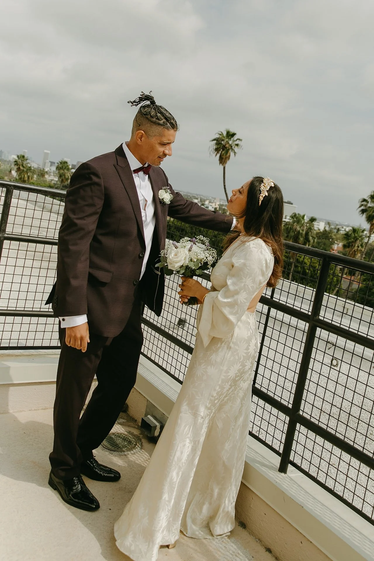 Newlyweds taking couple portraits outside the Beverly Hills courthouse