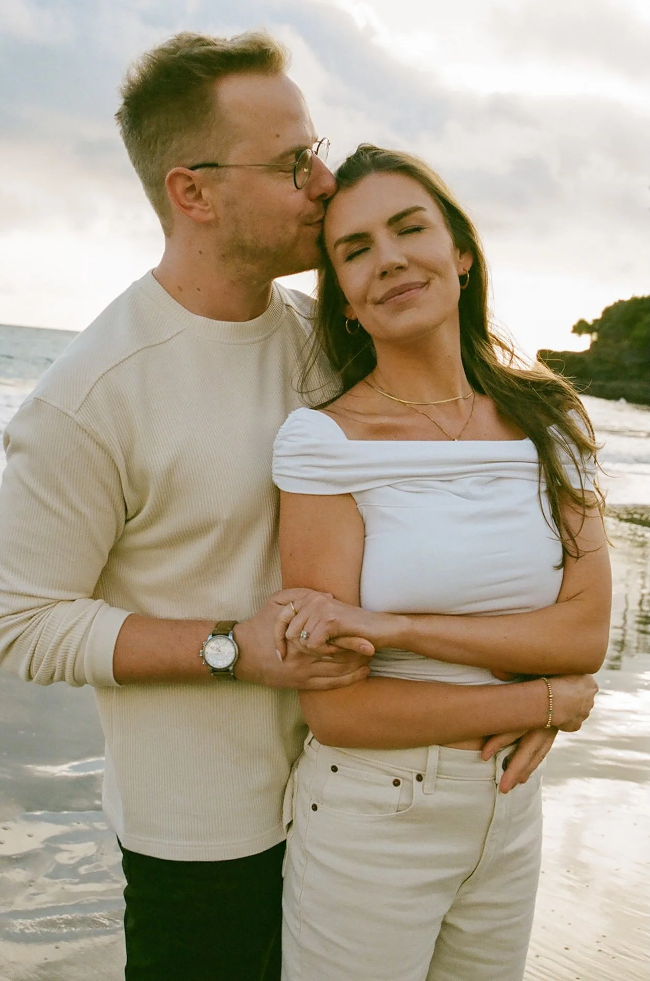 Couple hugging on the beach during their laguna beach engagement photos