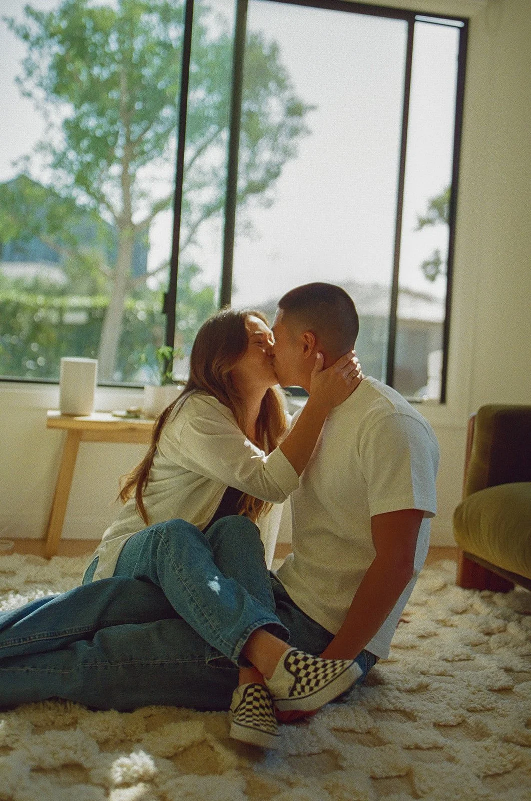 An intimate indoor engagement moment photographed near Venice Beach Photoshoot Locations with natural window light and soft tones.