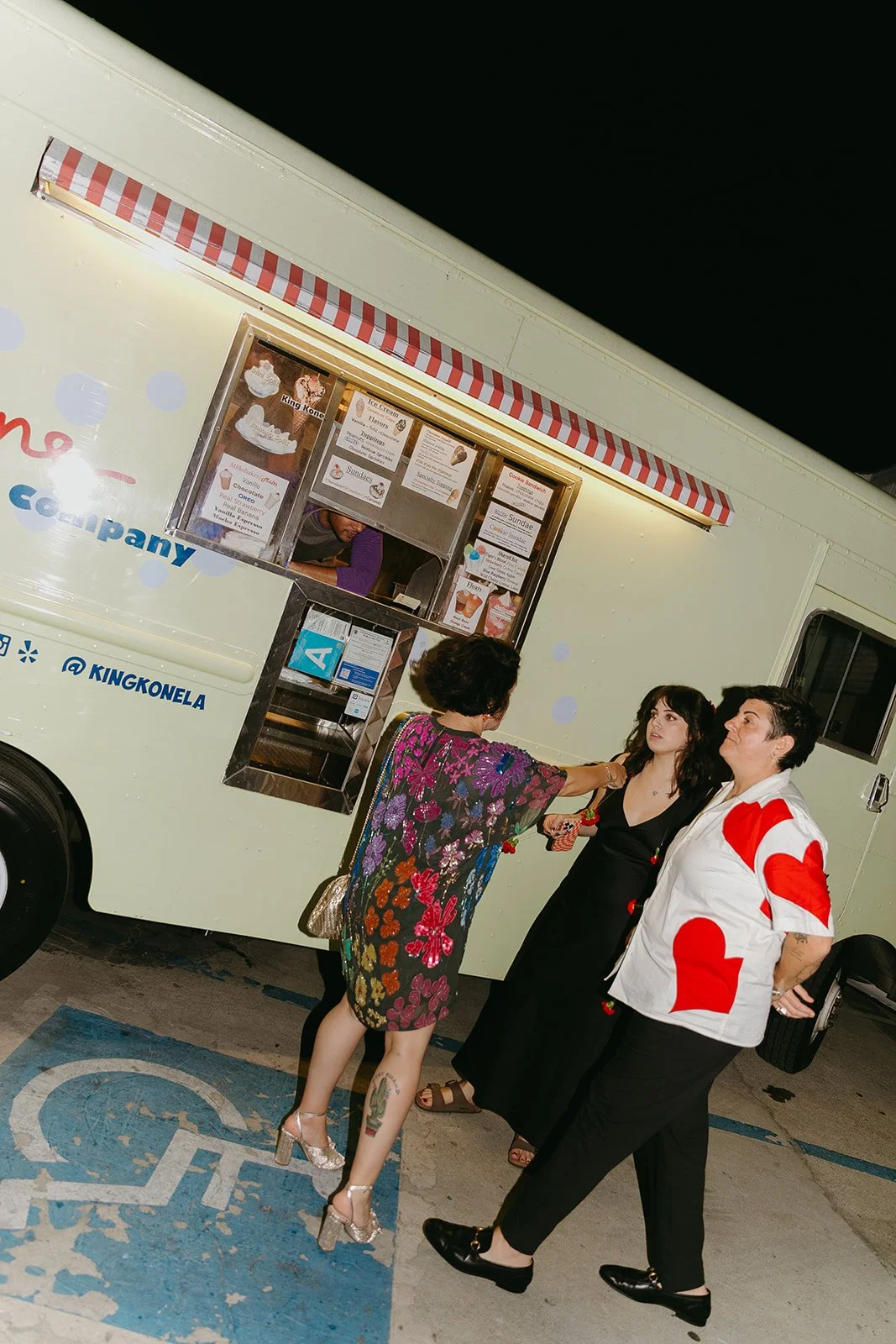 Guests in line and mingling at the ice cream truck that was a caterer at a vintage wedding.