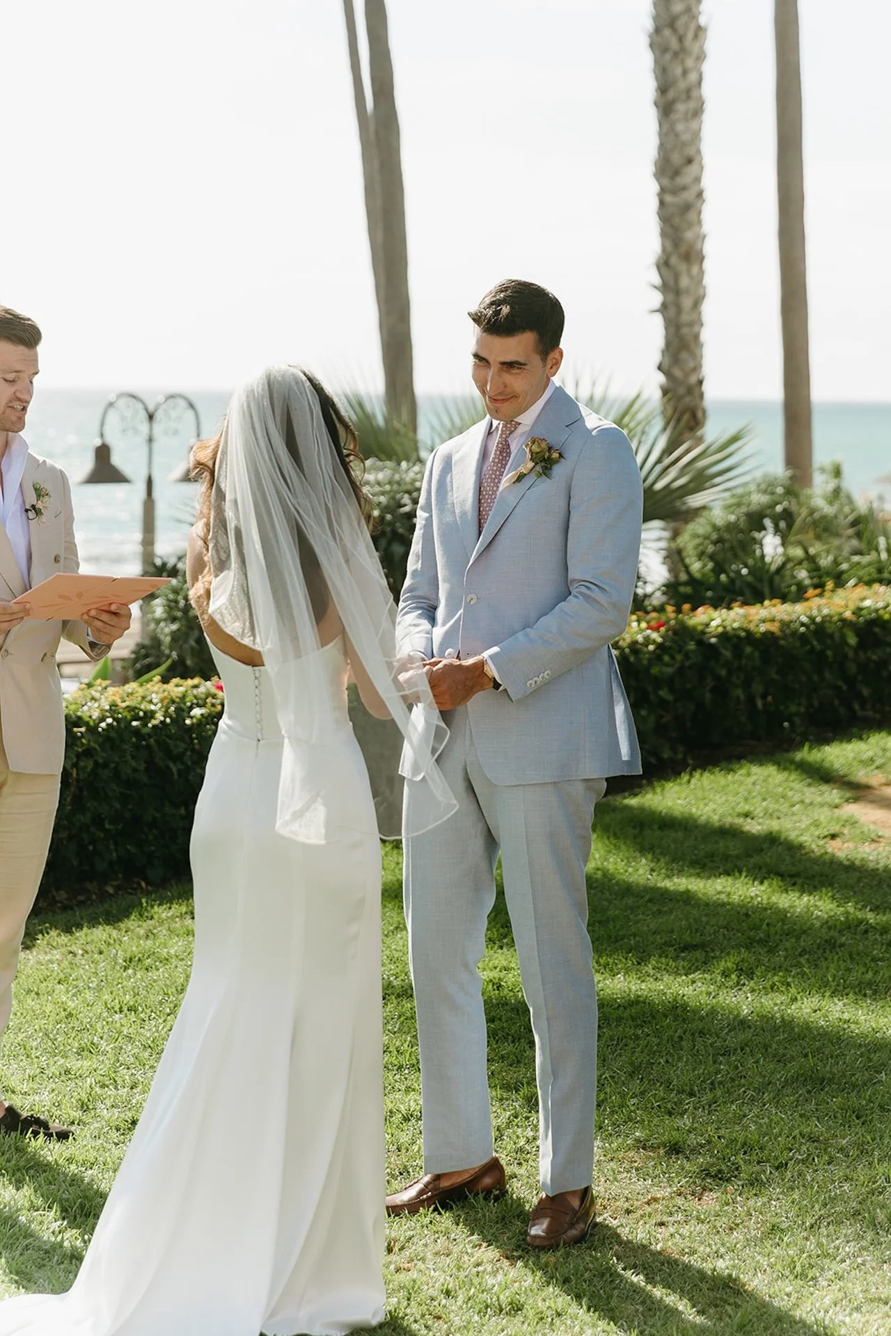 Close-up of the couple exchanging vows, highlighting emotional expressions and soft natural lighting.