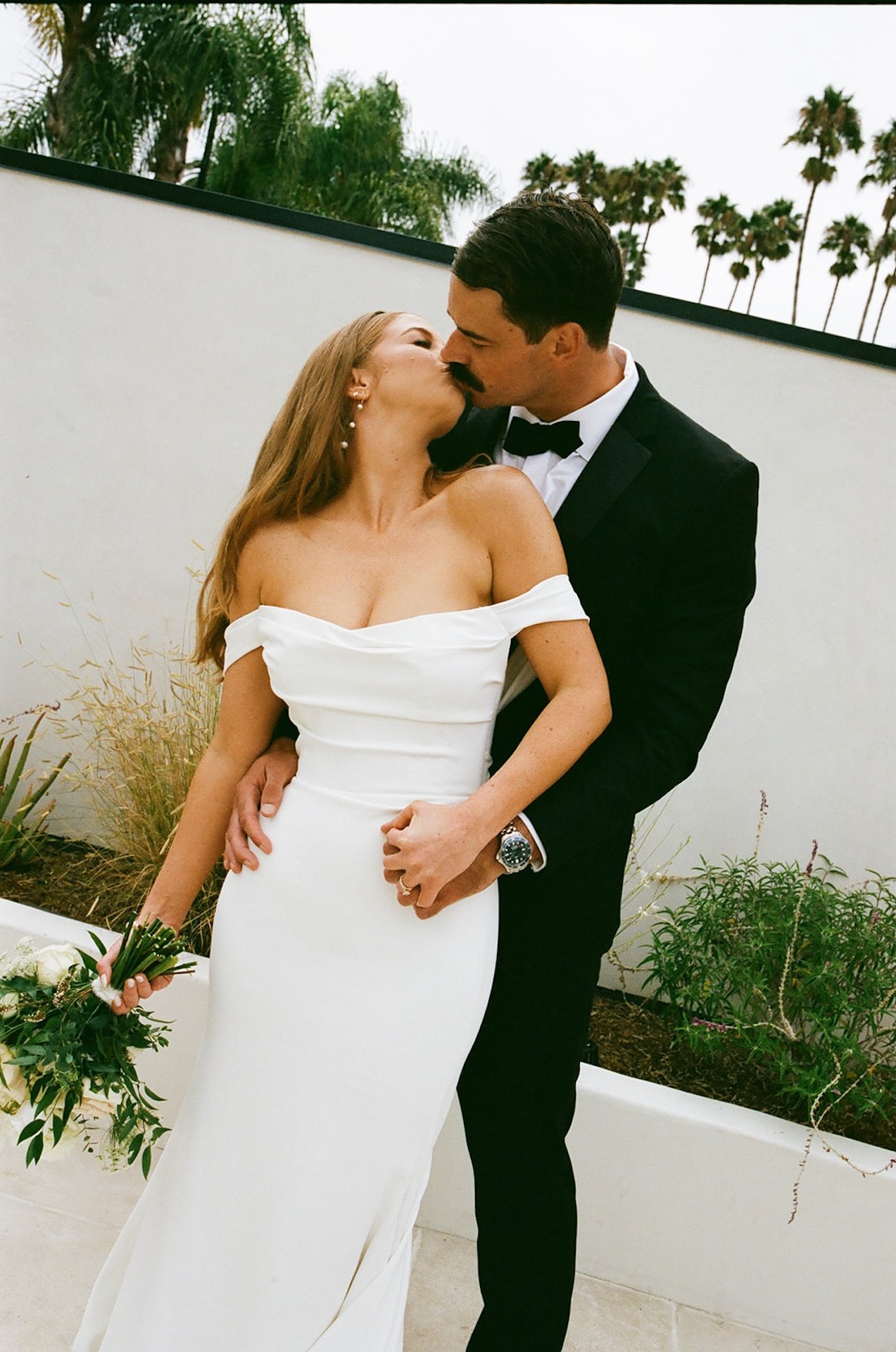 A couple sharing an intimate kiss after their wedding ceremony at a San Clemente Wedding Venue