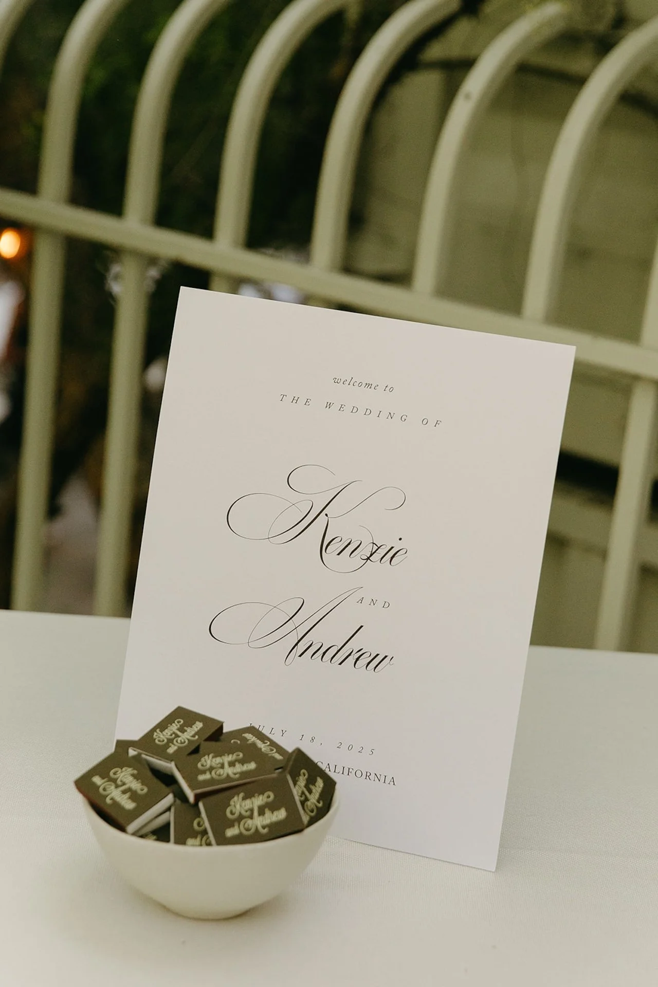 A minimalist welcome sign and custom matchbooks on a table, showcasing Intimate Wedding Ideas for modern wedding stationery details.