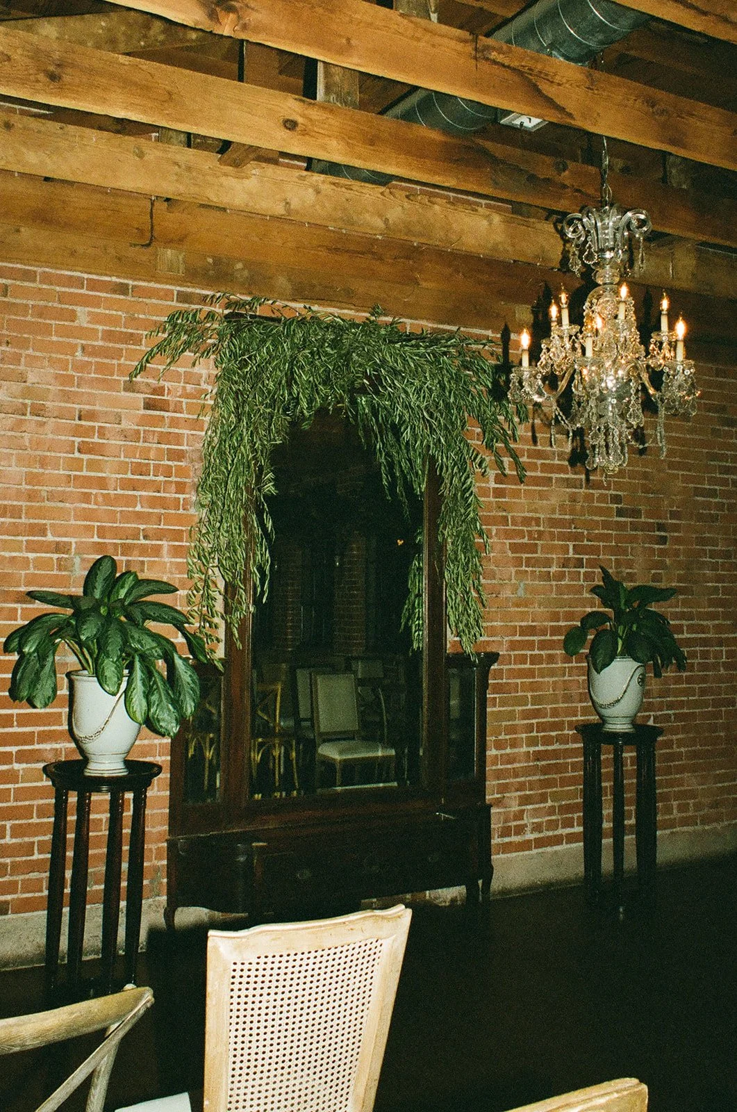 A flash lit photo of a wedding ceremony arch of greenery at a moody DTLA wedding venue