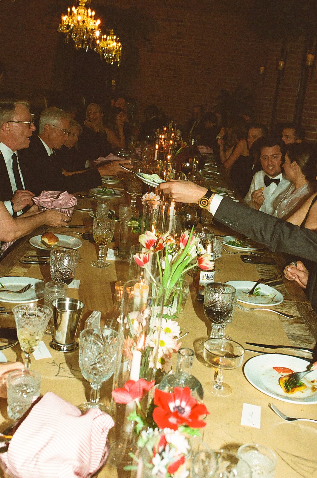A flash photo of guests chatting and eating their God-father inspired dinner at a unique DTLA wedding venue