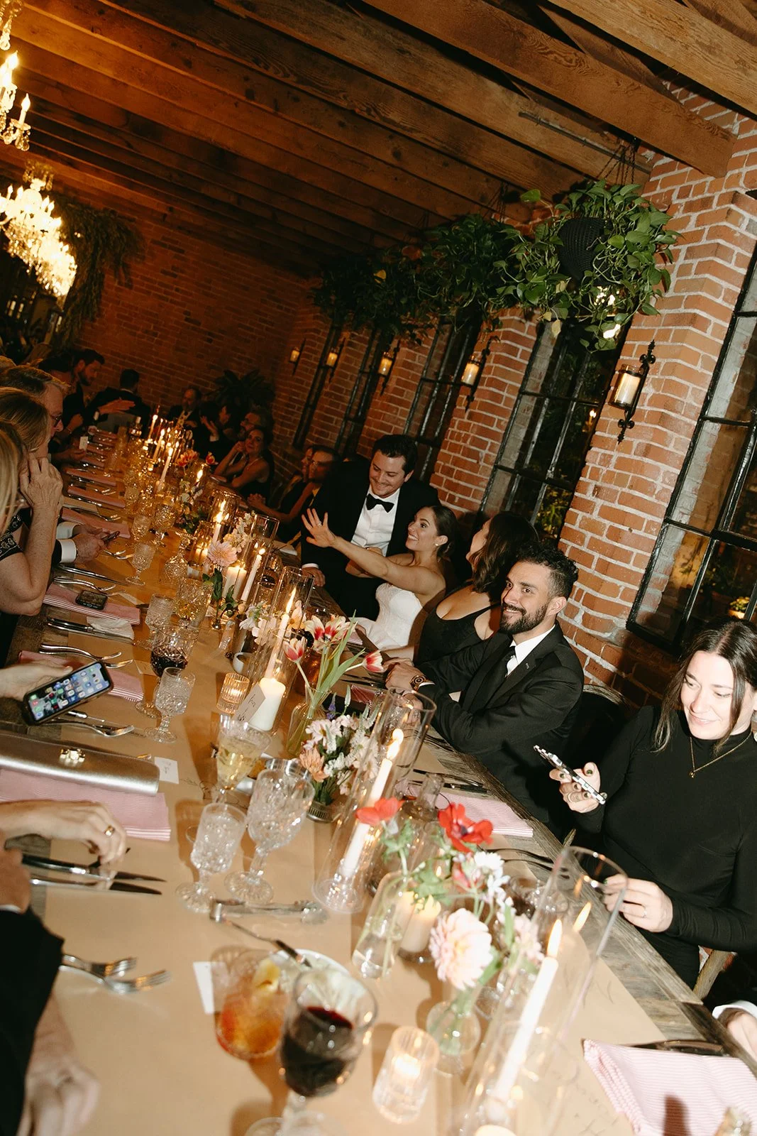 A flash photo of guests chatting and eating their God-father inspired dinner at a unique DTLA wedding venue