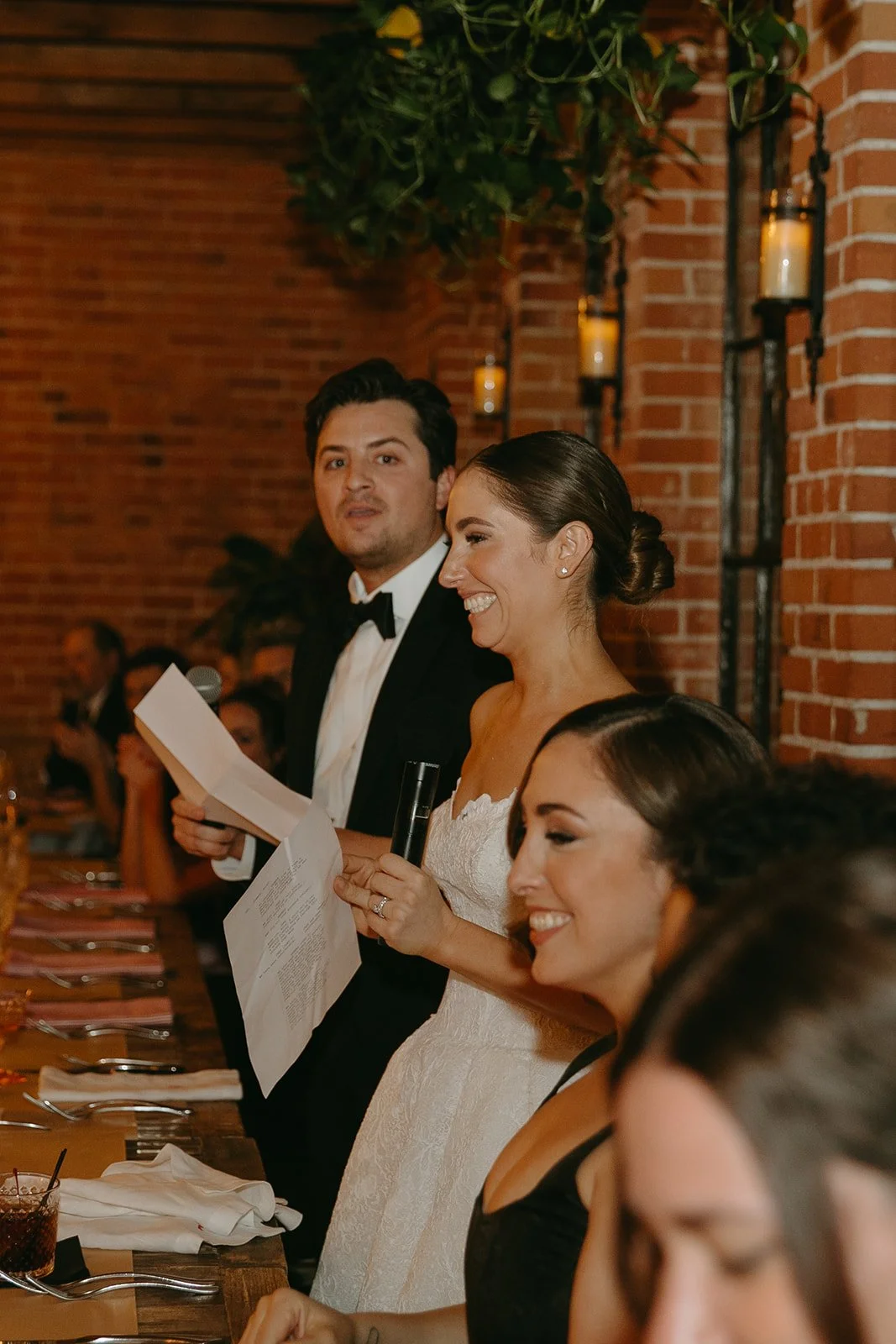 The bride and groom standing and giving a speech at their DTLA wedding venue