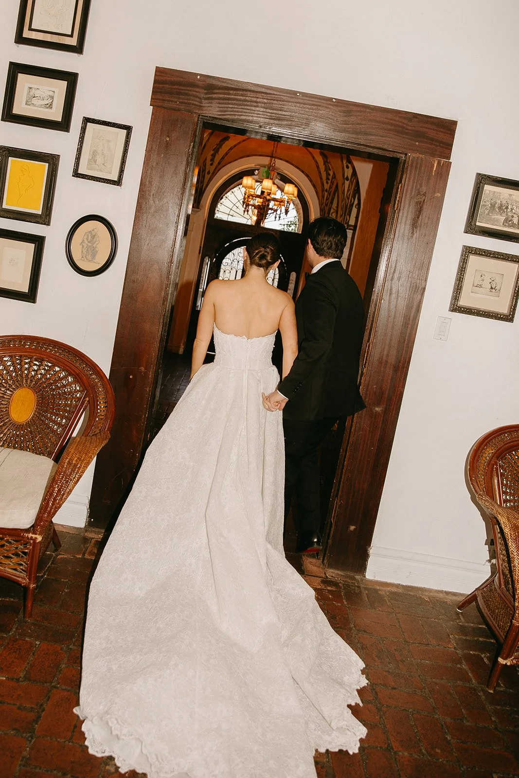 The bride and groom walking hand in hand into their  DTLA wedding venue