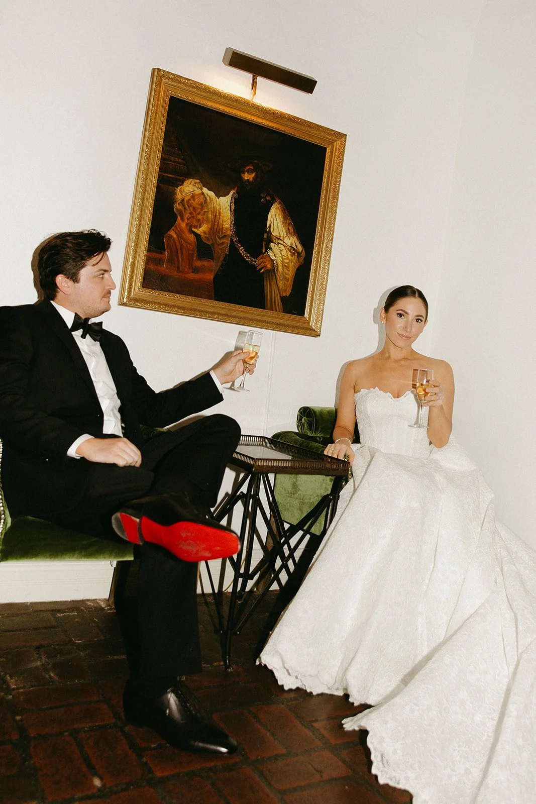 Editorial bride and groom portraits at the Carondelet House, a DTLA wedding venue. Holding up champagne glasses and looking softly at the camera