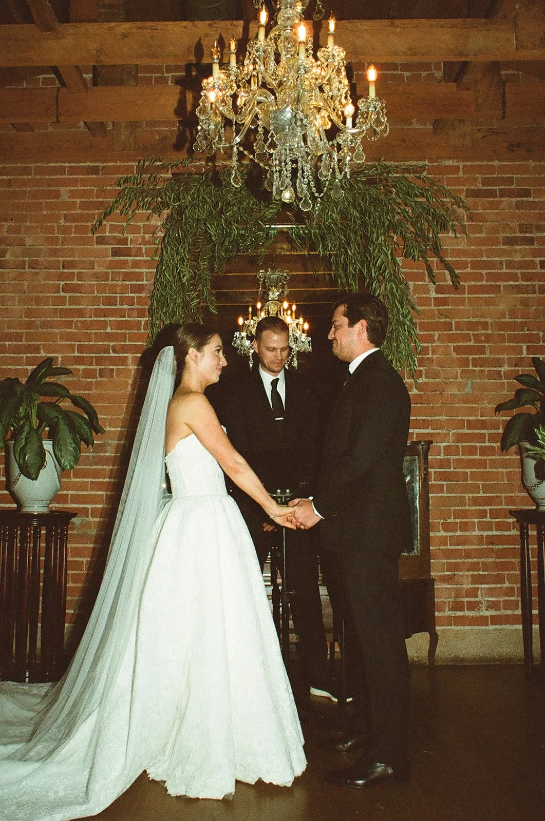 The bride and groom holding hands at the alter during their wedding ceremony at the Carondelet House, a Editorial bride and groom portraits at the Carondelet House, a DTLA wedding venue