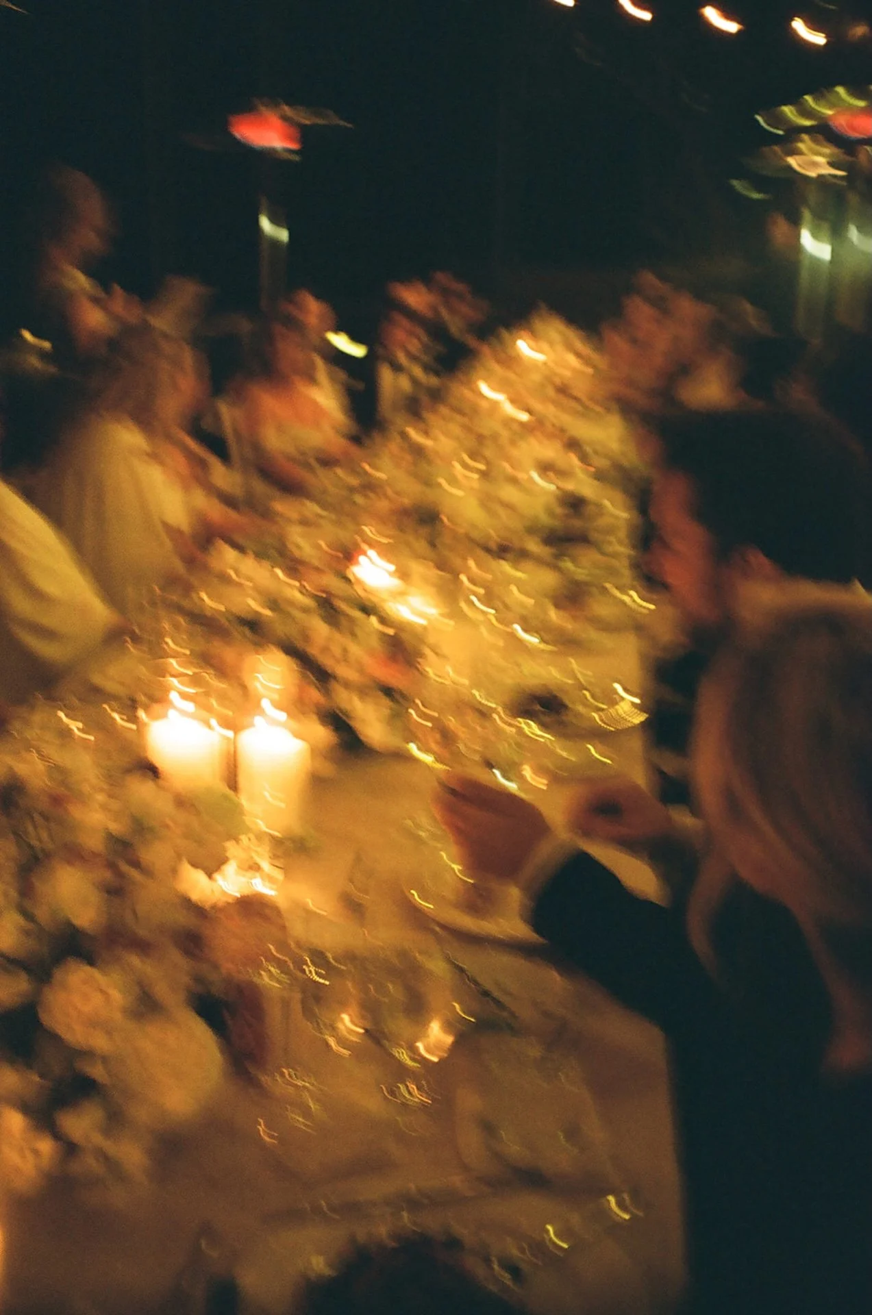 Candlelit wedding reception dinner with guests seated along a floral filled tablescape at The Ranch at Laguna Beach wedding.