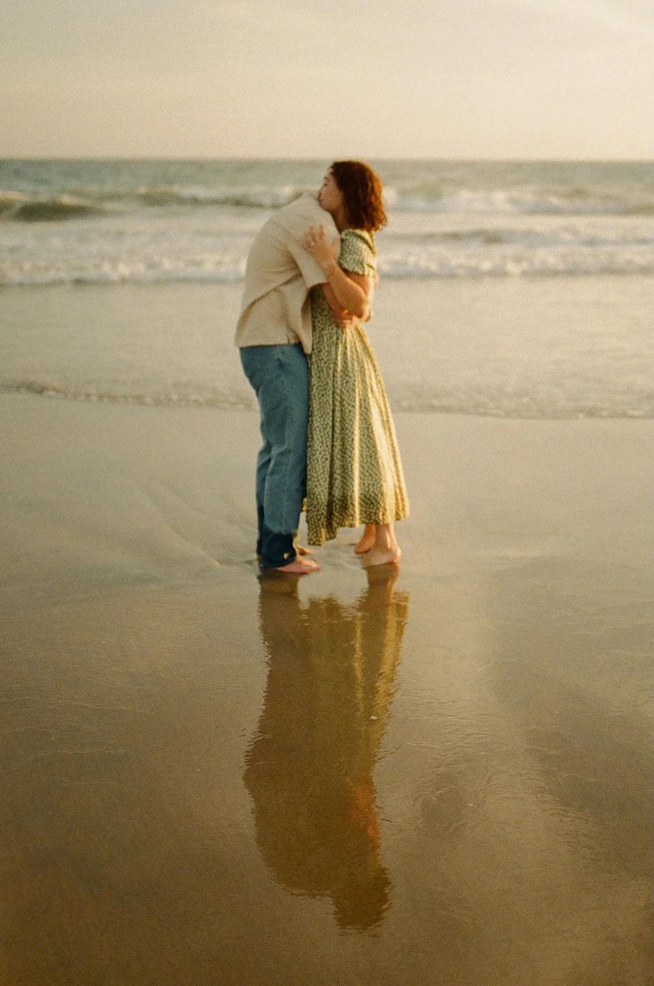 Romantic portrait photo of a couple embracing on the beach during their newport beach engagement photos.