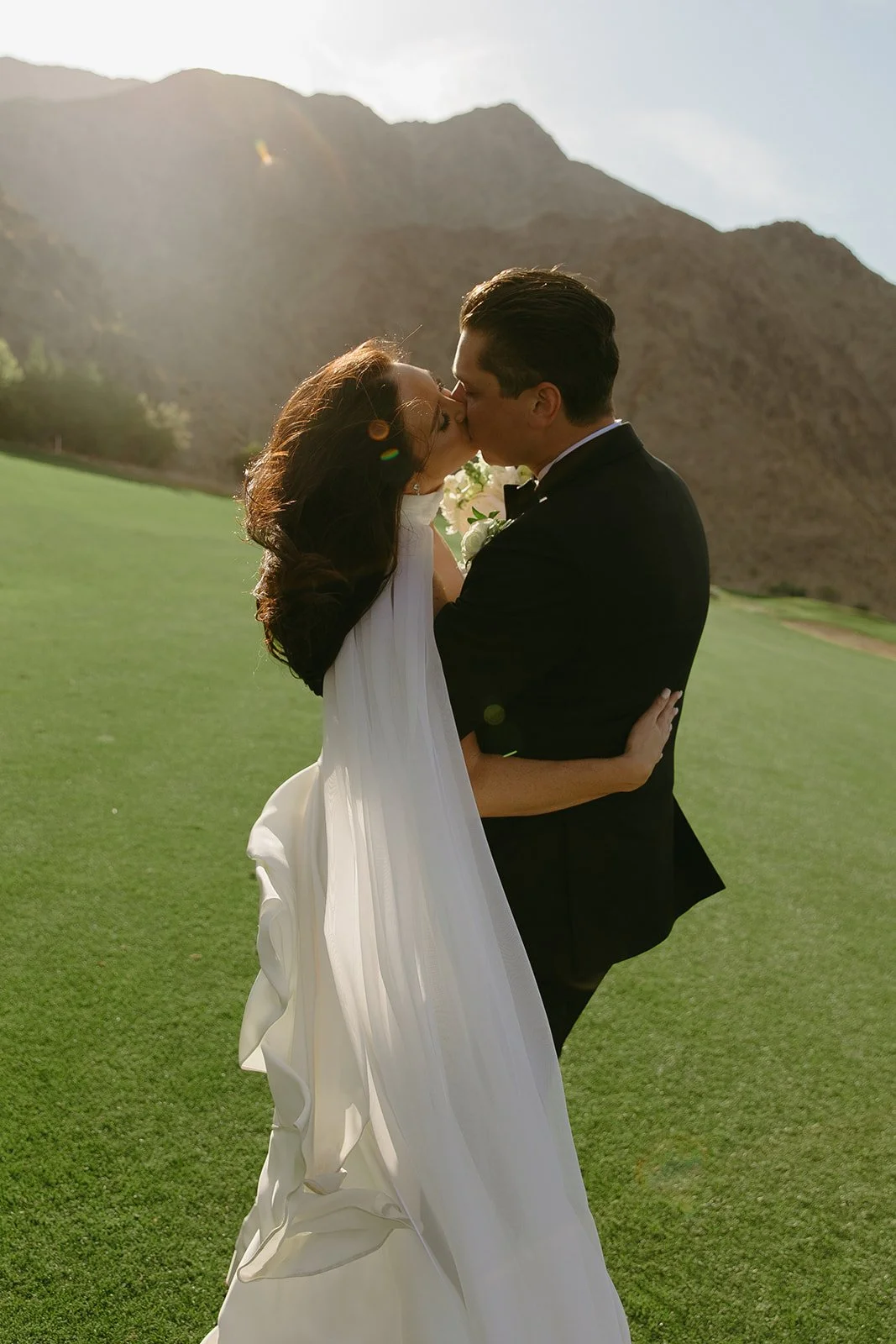 A bride and groom on the lawn at Palm Springs wedding venue PGA west
