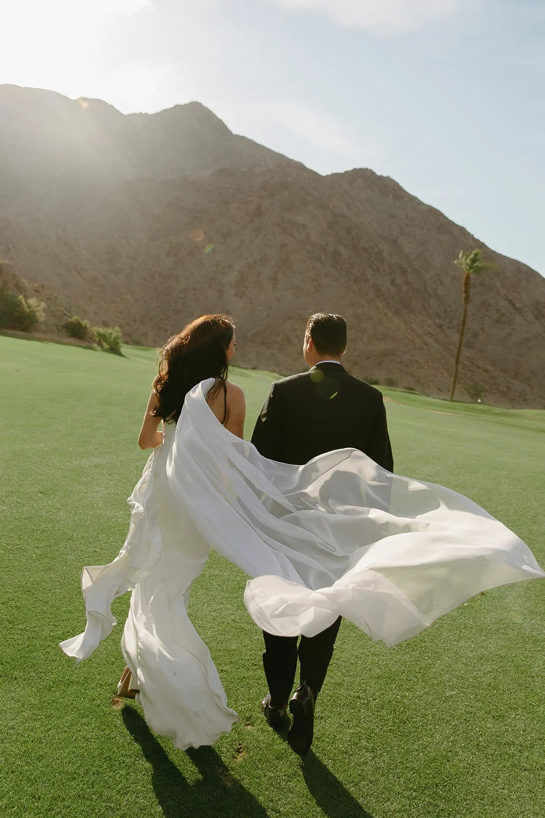 A bride and groom on the lawn at Palm Springs wedding venue PGA west