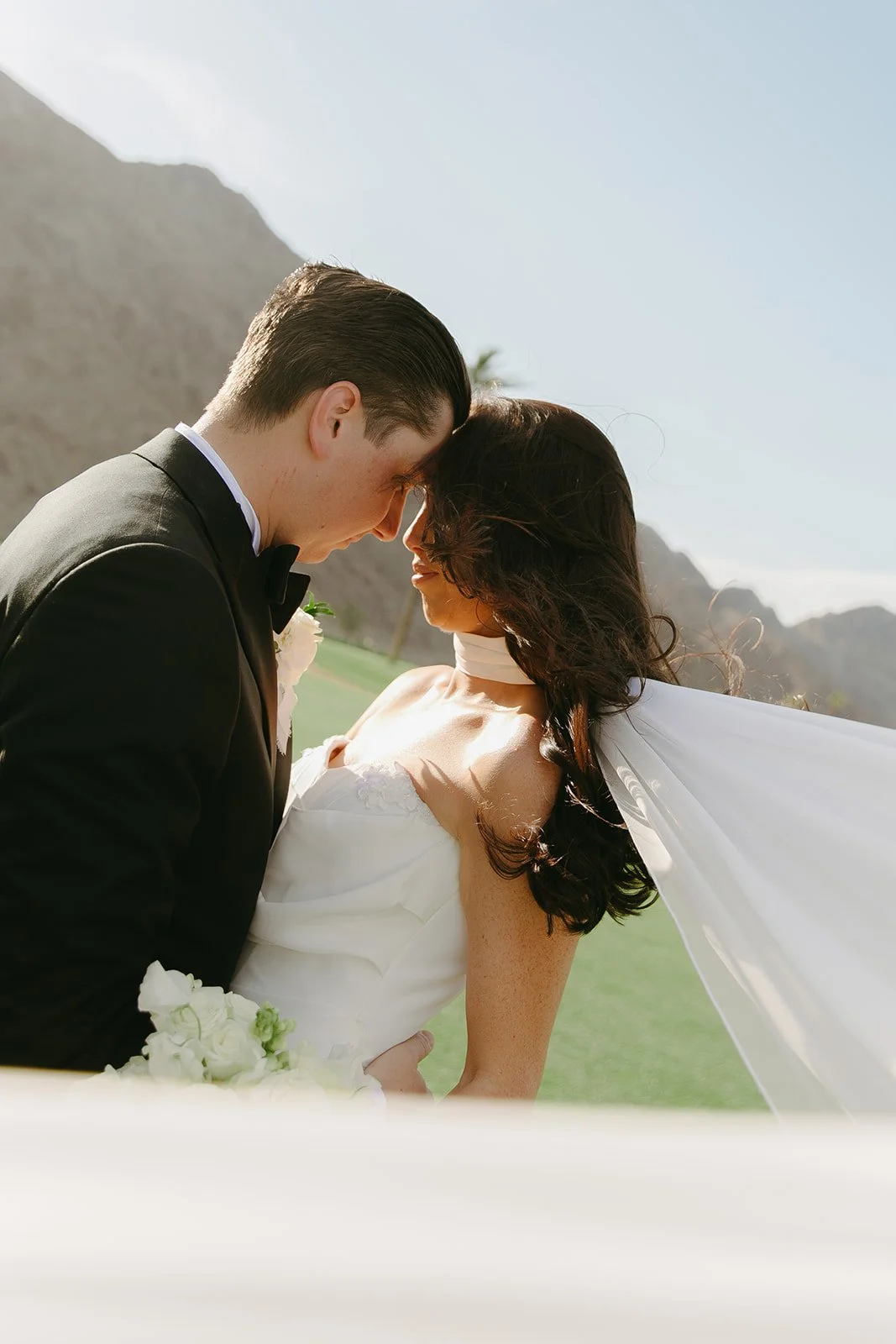 A bride and groom on the lawn at Palm Springs wedding venue PGA west