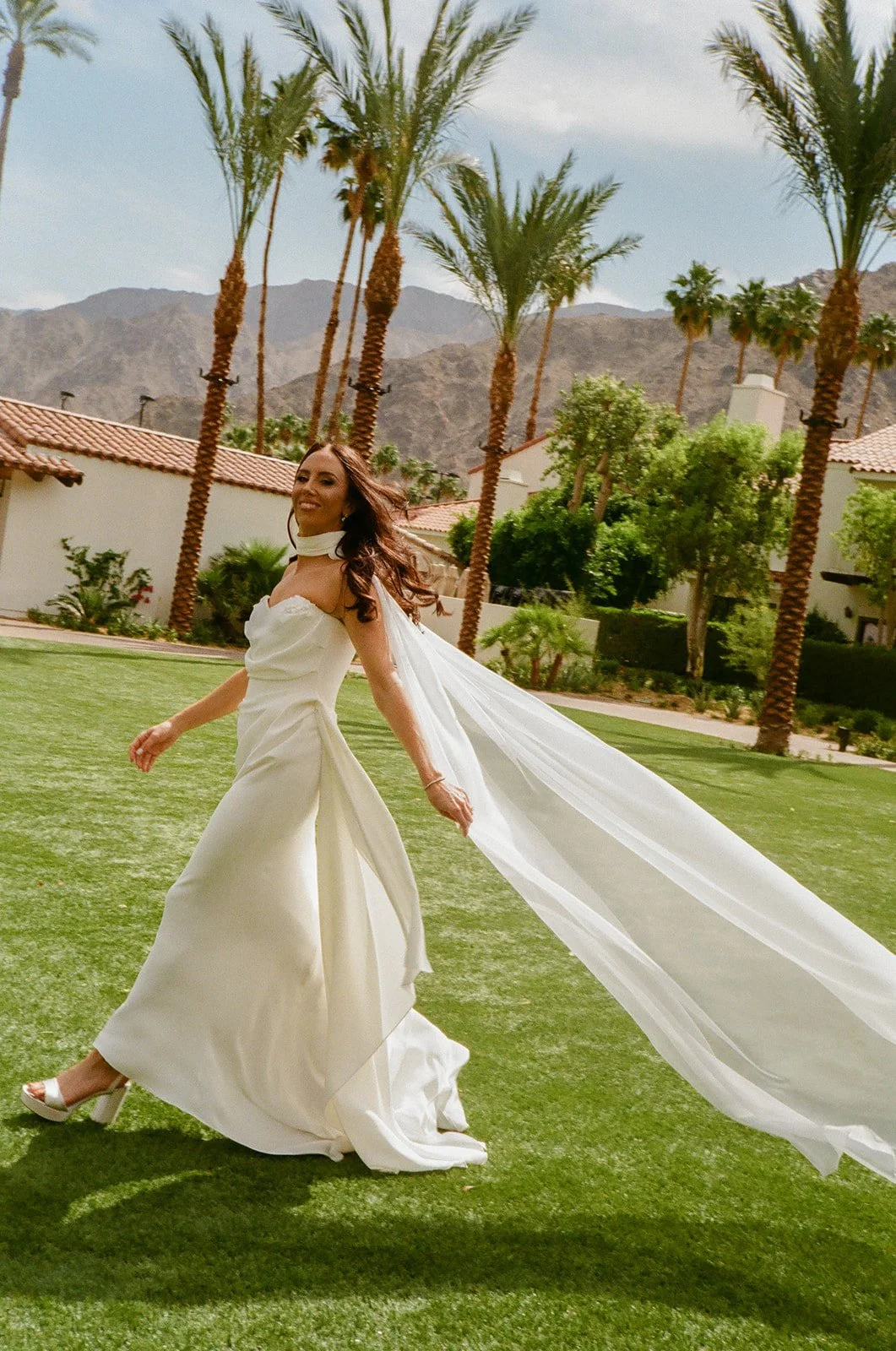 A bride walking across the lawn at PGA West 