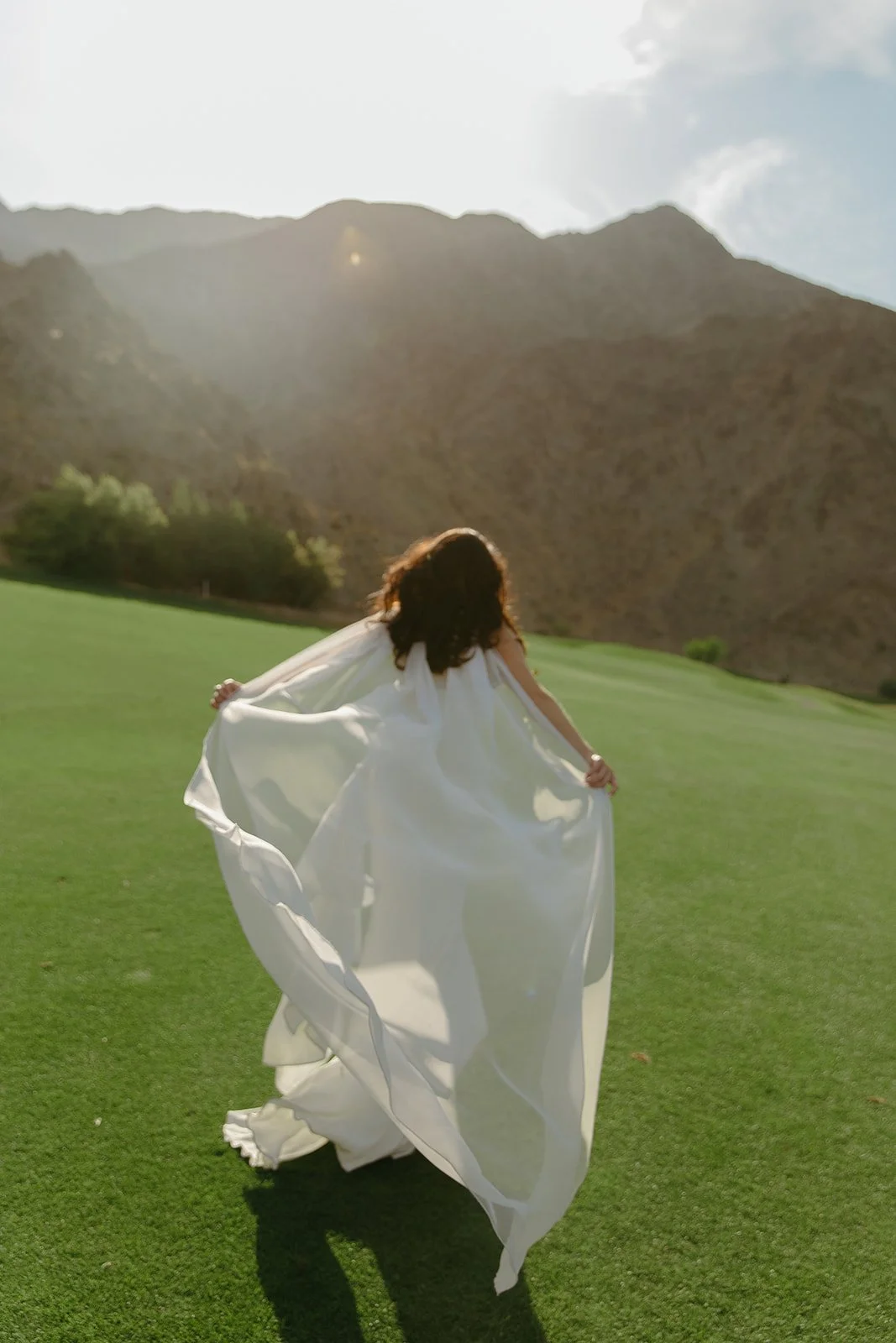 A bride walking away from the camera at her Palm Springs wedding venue