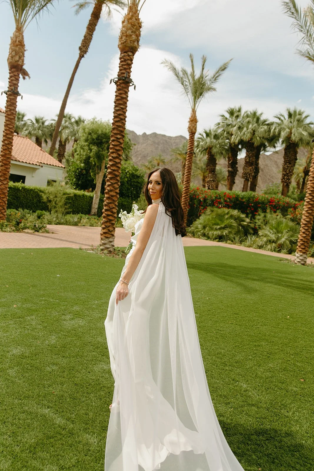 A bride walking away from the camera at her Palm Springs wedding venue