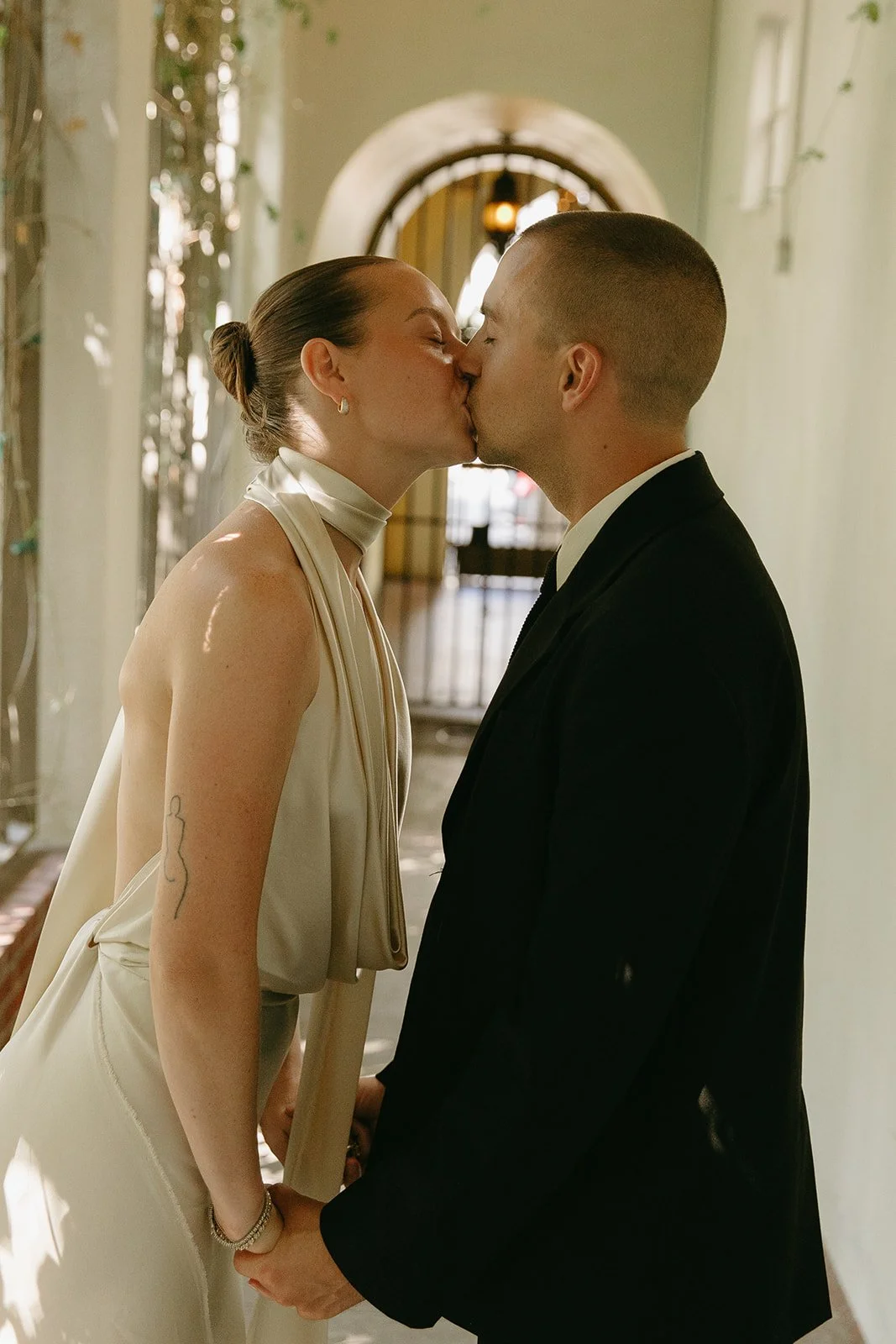 A bride and groom kissing at their unique wedding venue, Redbird