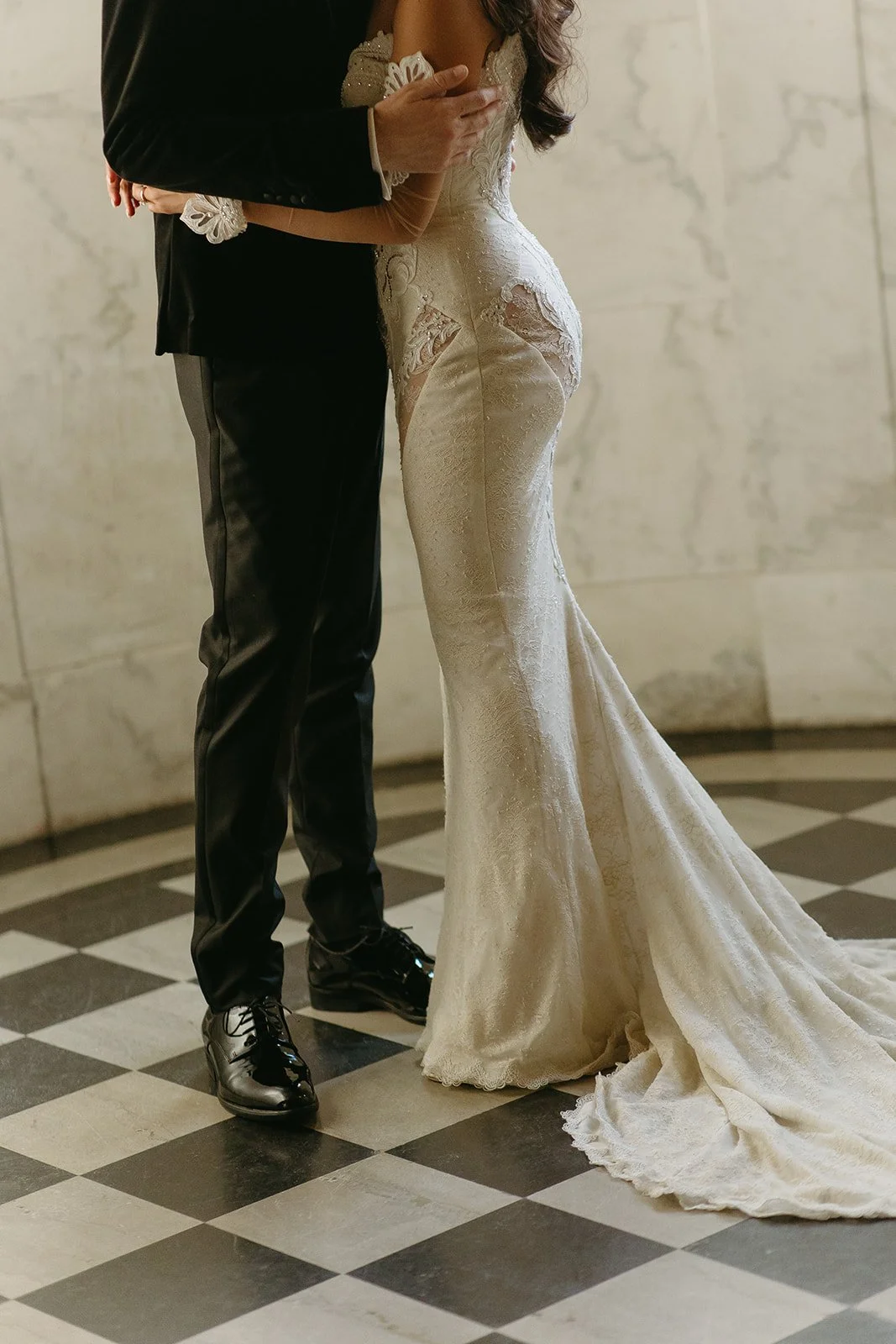 A bride and groom posing for photos inside of Vibiana