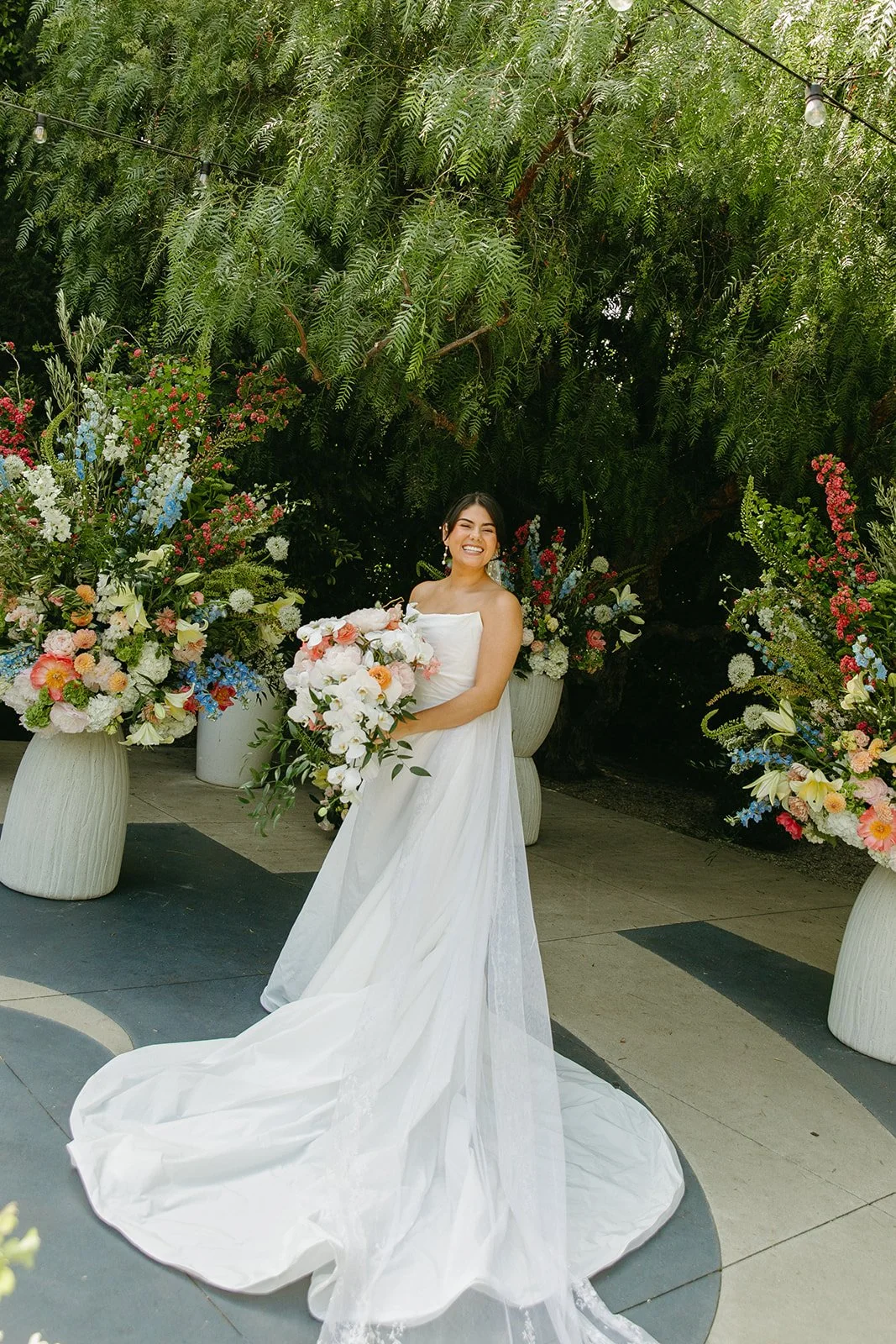 A bride holding a bouquet at The Fig House, her unique wedding venue