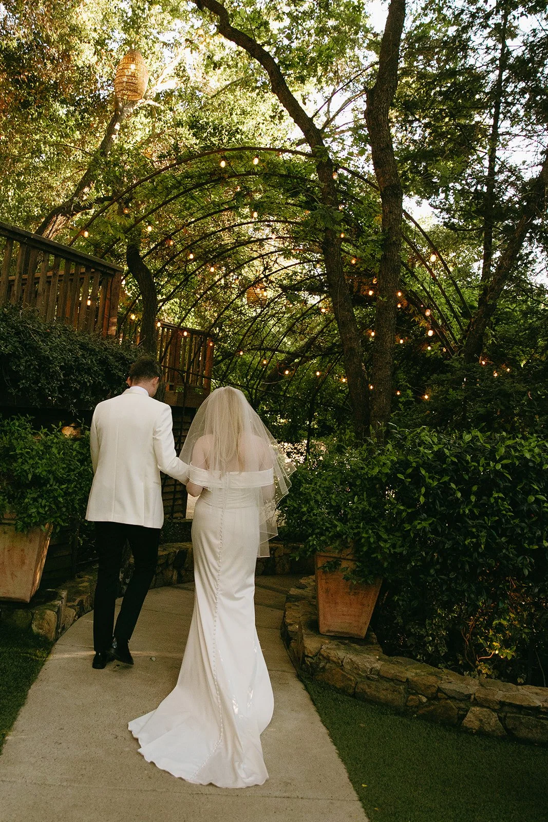 A bride and groom walkinga way from the camera t their Malibu Wedding venue