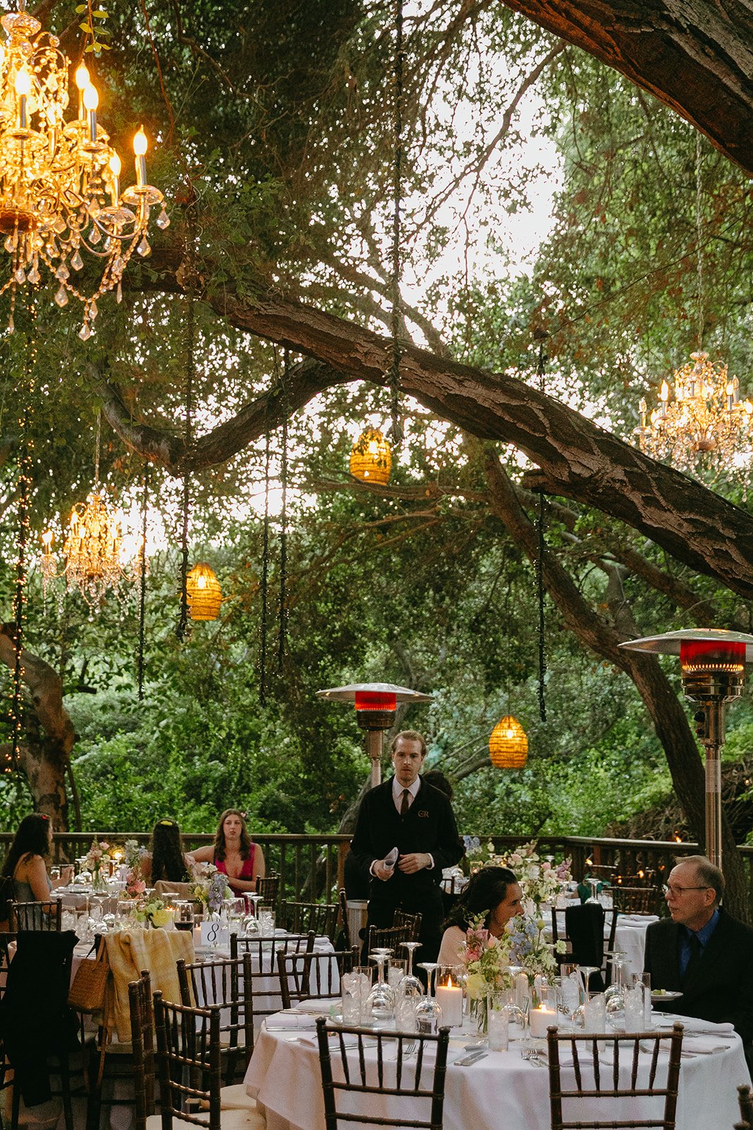 An outdoor wedding reception with string lights