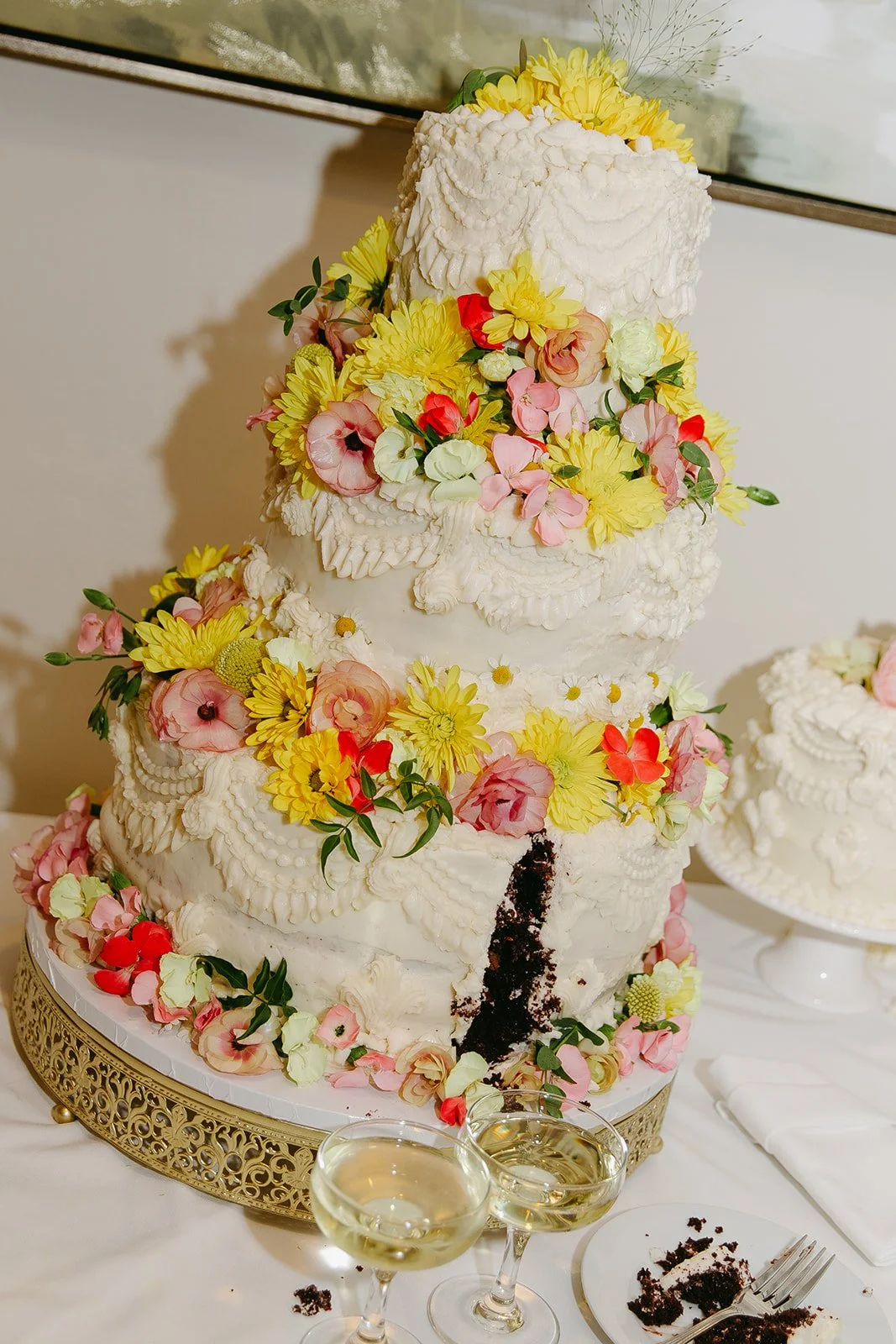 A wedding cake with lots of colorful flowers