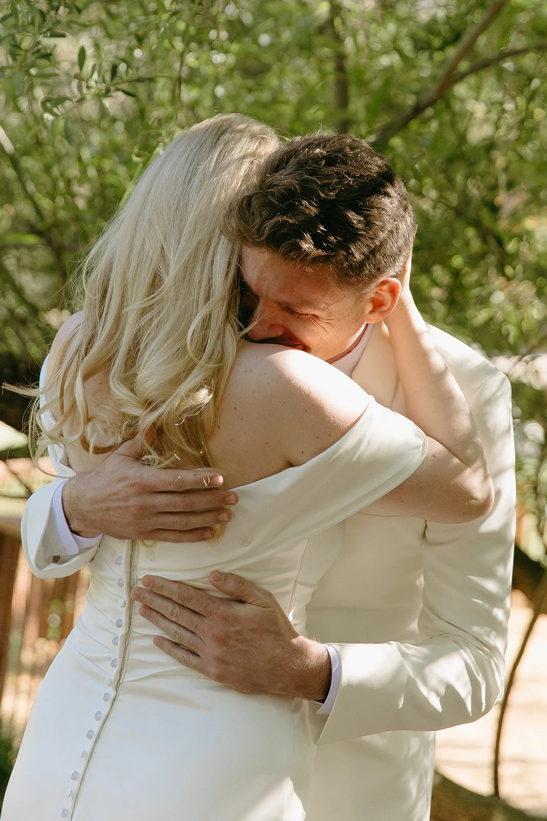A bride and groom hugging during their first look