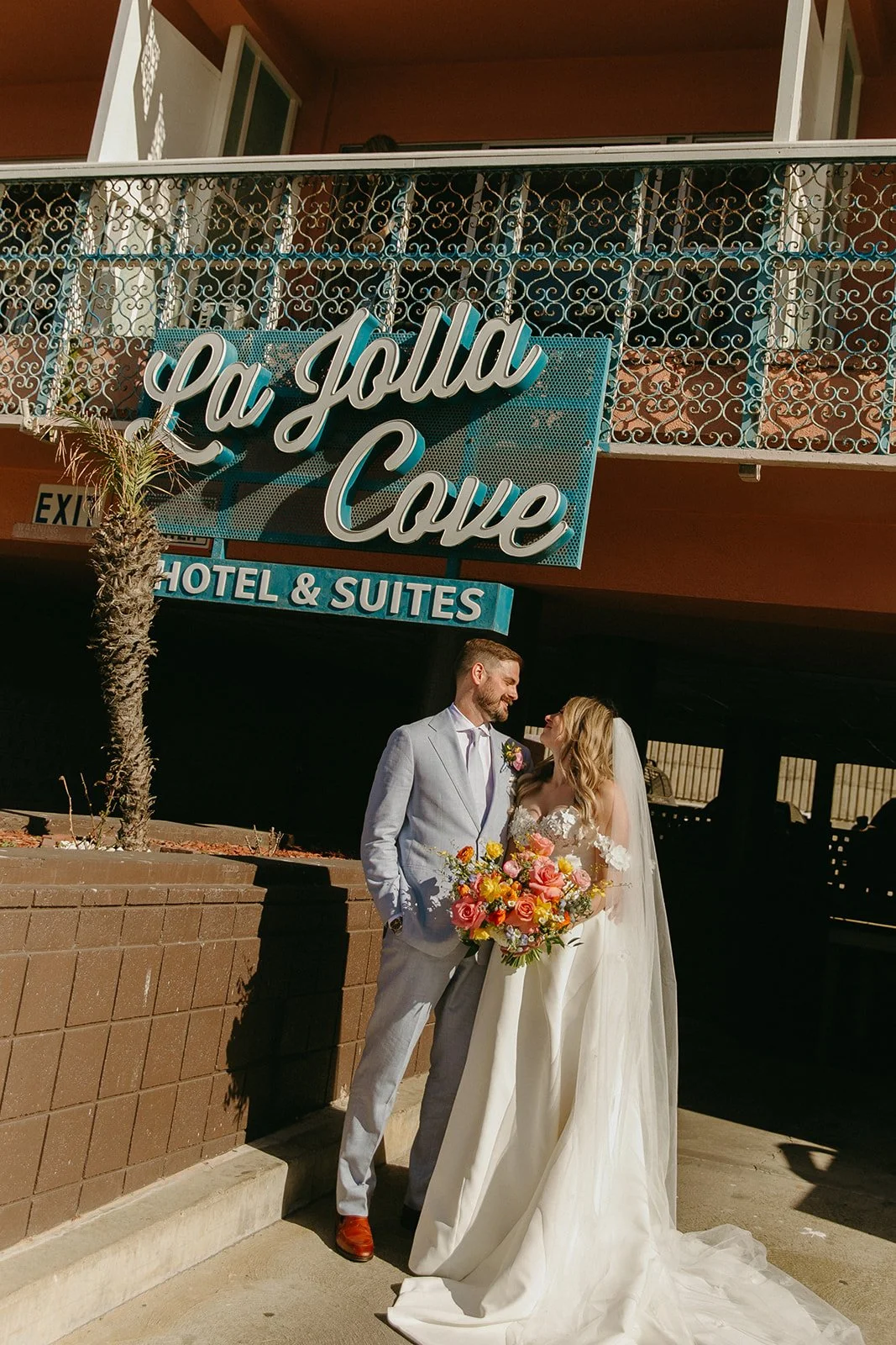 A bride and groom outside of their unique wedding venue, La Jolla