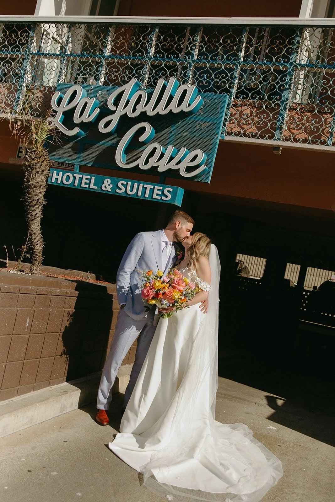 A bride and groom outside of their unique wedding venue, La Jolla
