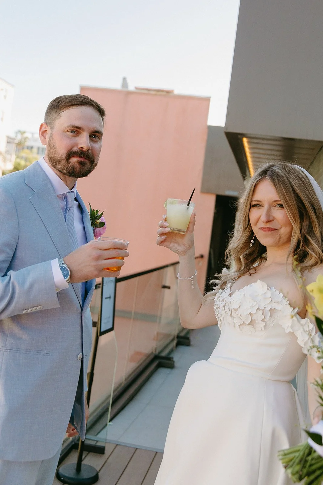 A bride and groom having a cocktail together after their wedding ceremony