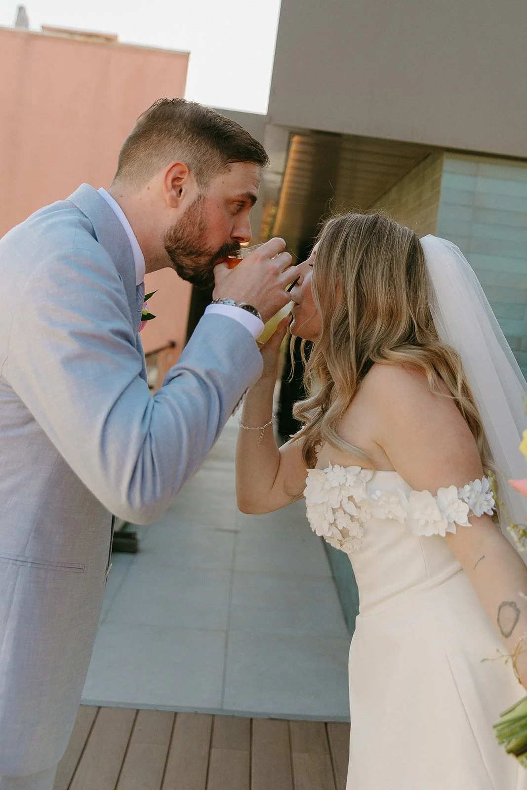 A bride and groom having a cocktail together after their wedding ceremony
