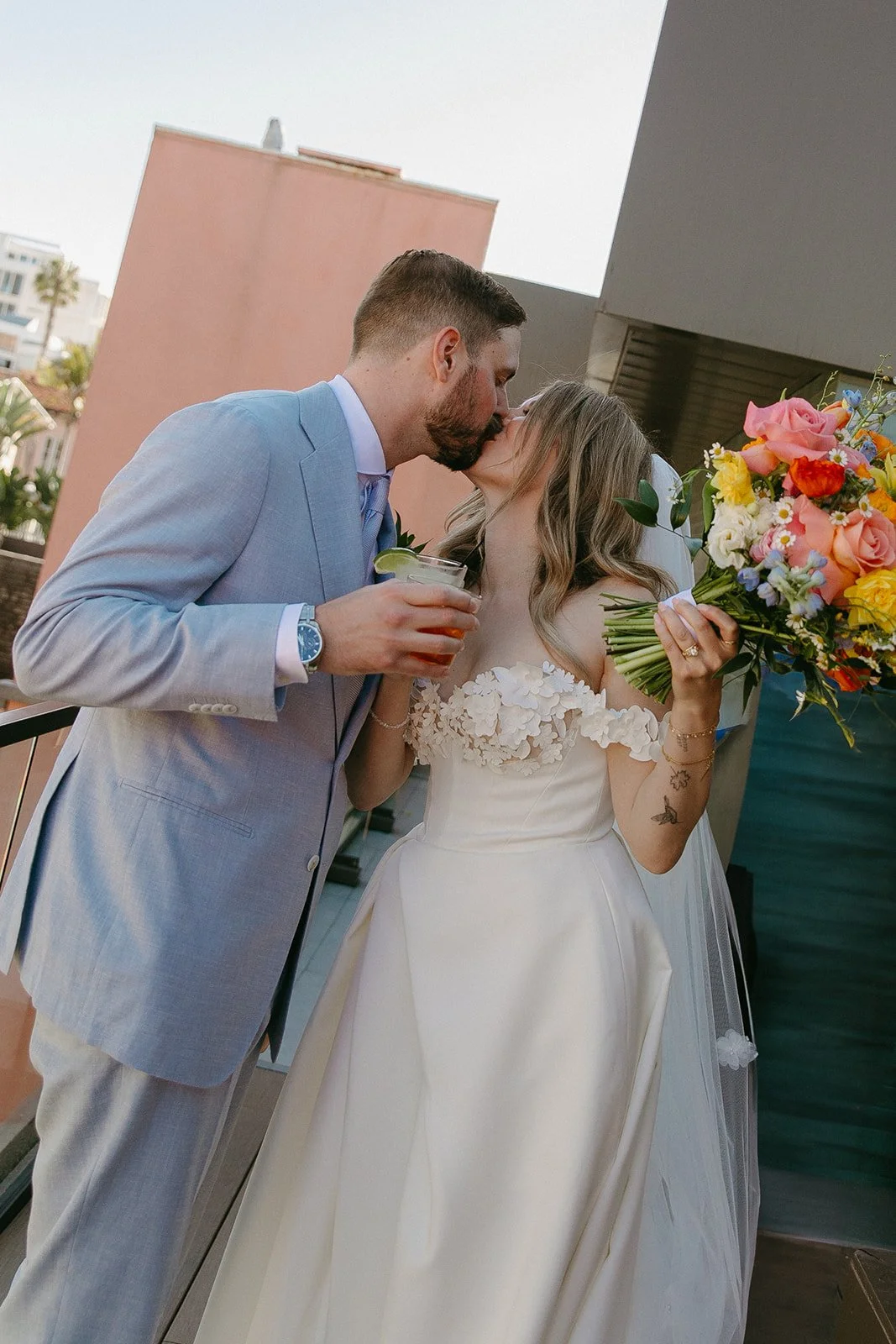 A bride and groom having a cocktail together after their wedding ceremony