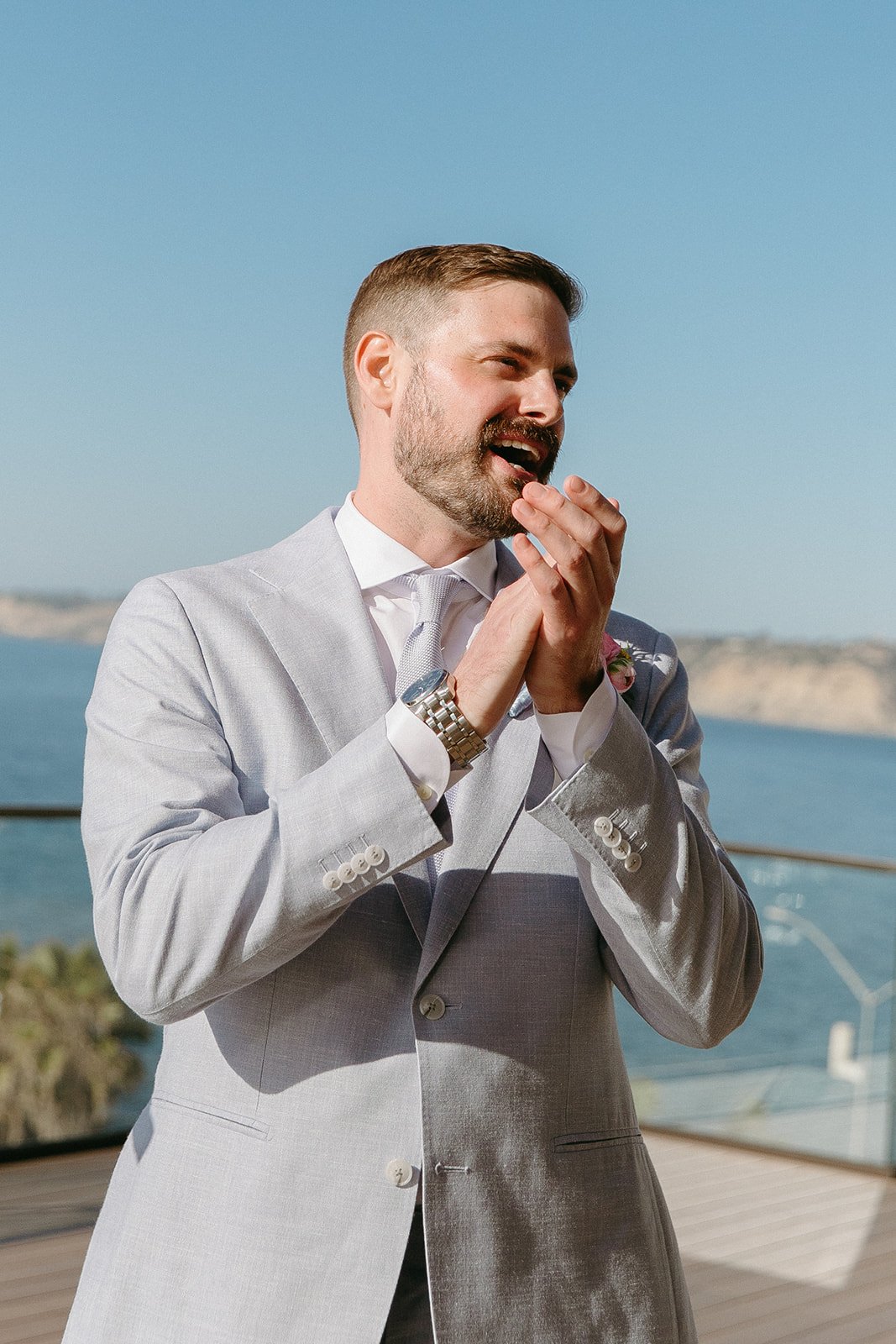A groom watching a bride walk down the aisle