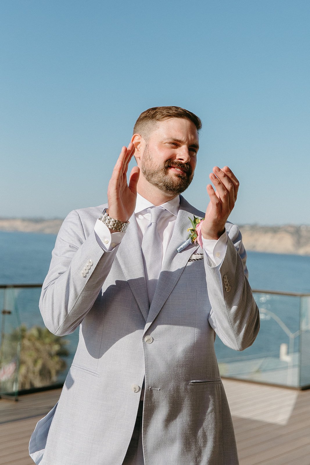 A groom watching a bride walk down the aisle