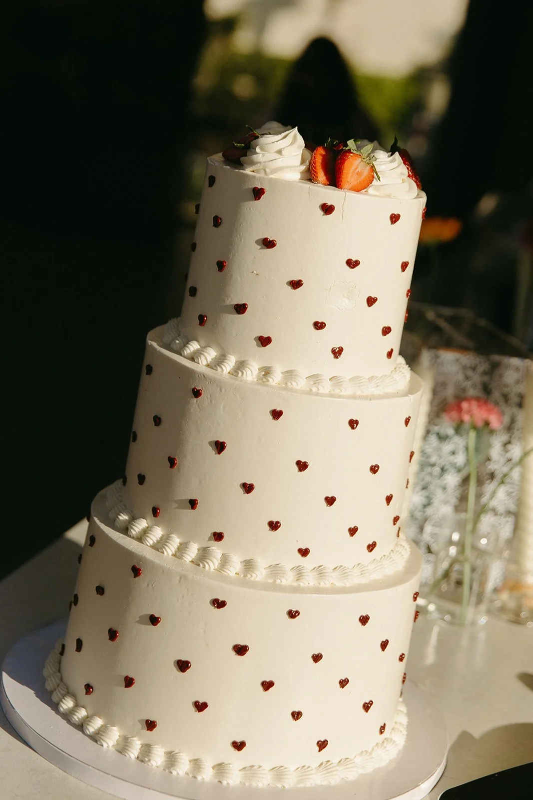 A wedding cake at a colorful wedding with hearts