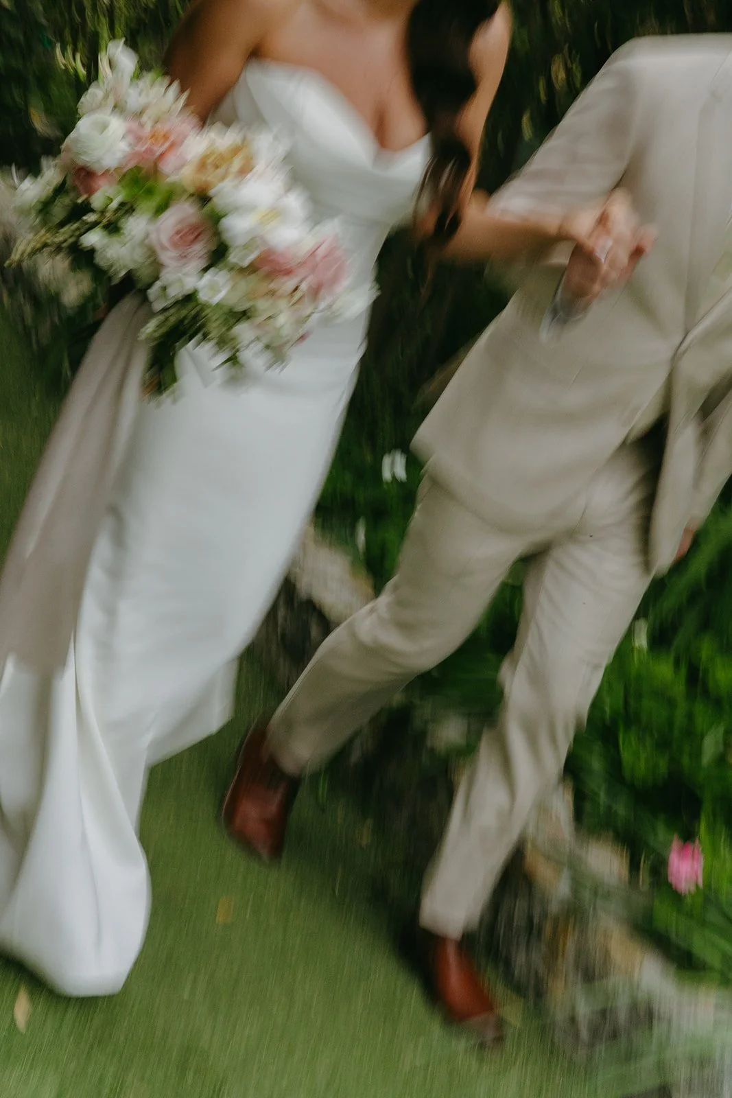 A blurry wedding photo of a bride and groom walking
