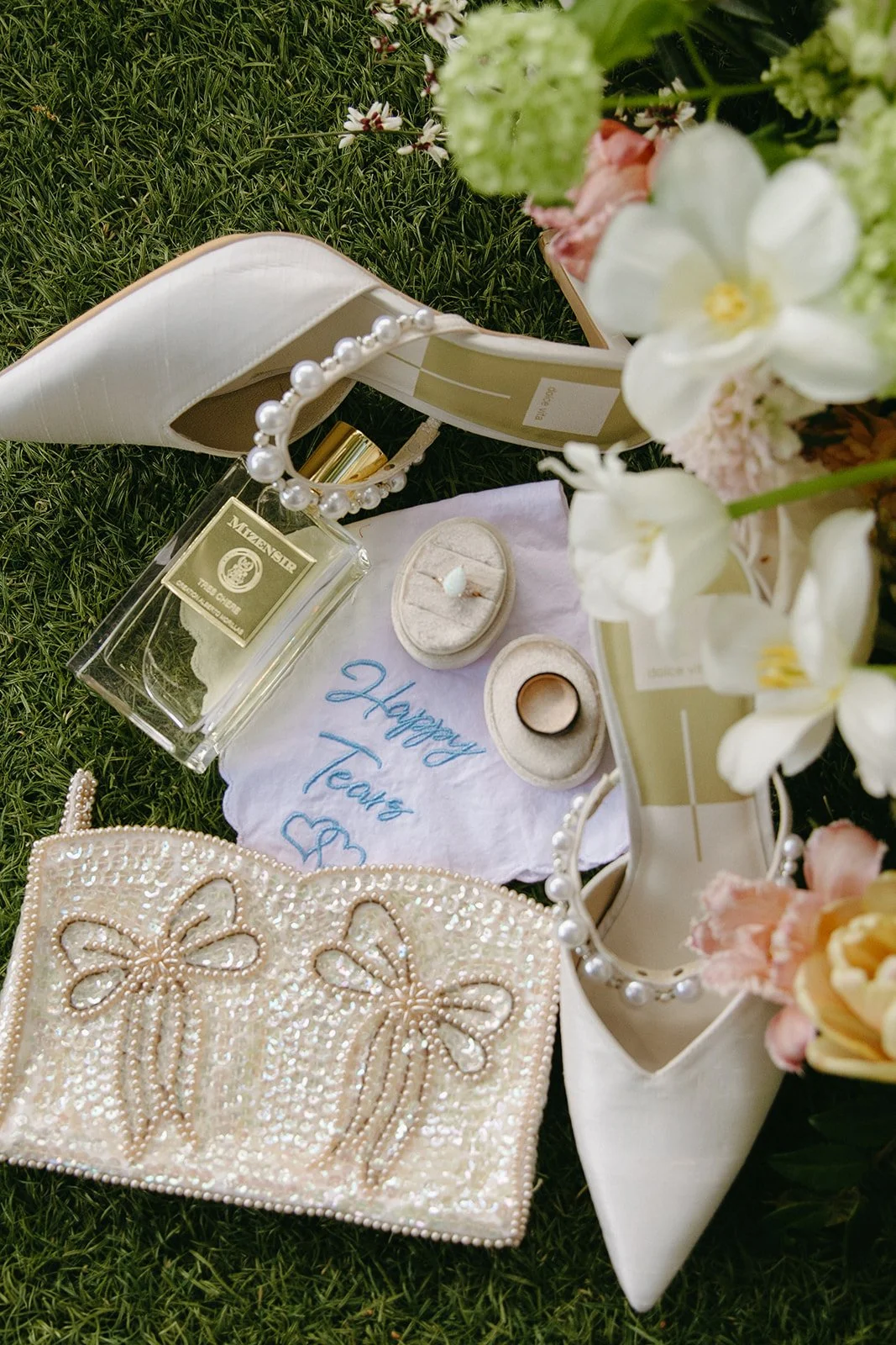 A wedding flat lay with flowers and wedding shoes on the ground