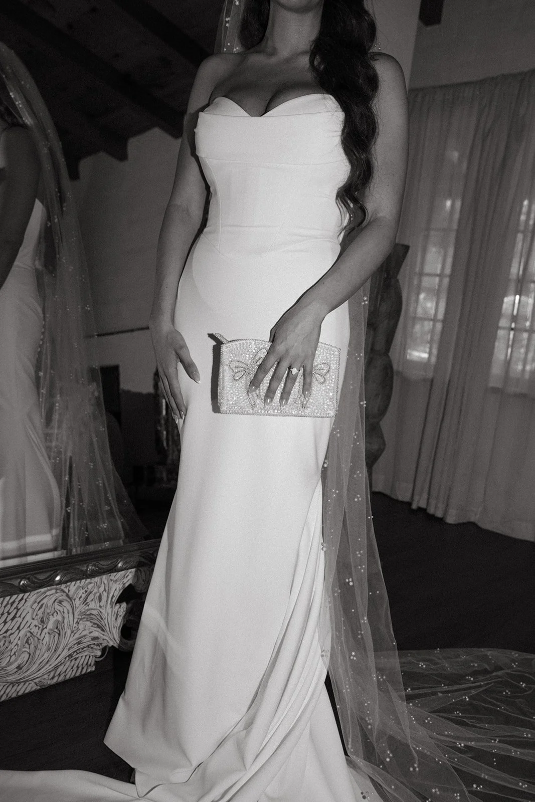 A bride getting ready for her wedding in a black and white photo