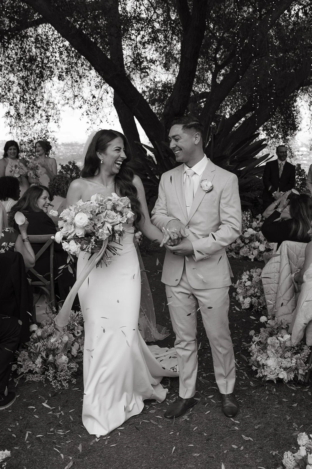A bride and groom celebrating after their wedding ceremony