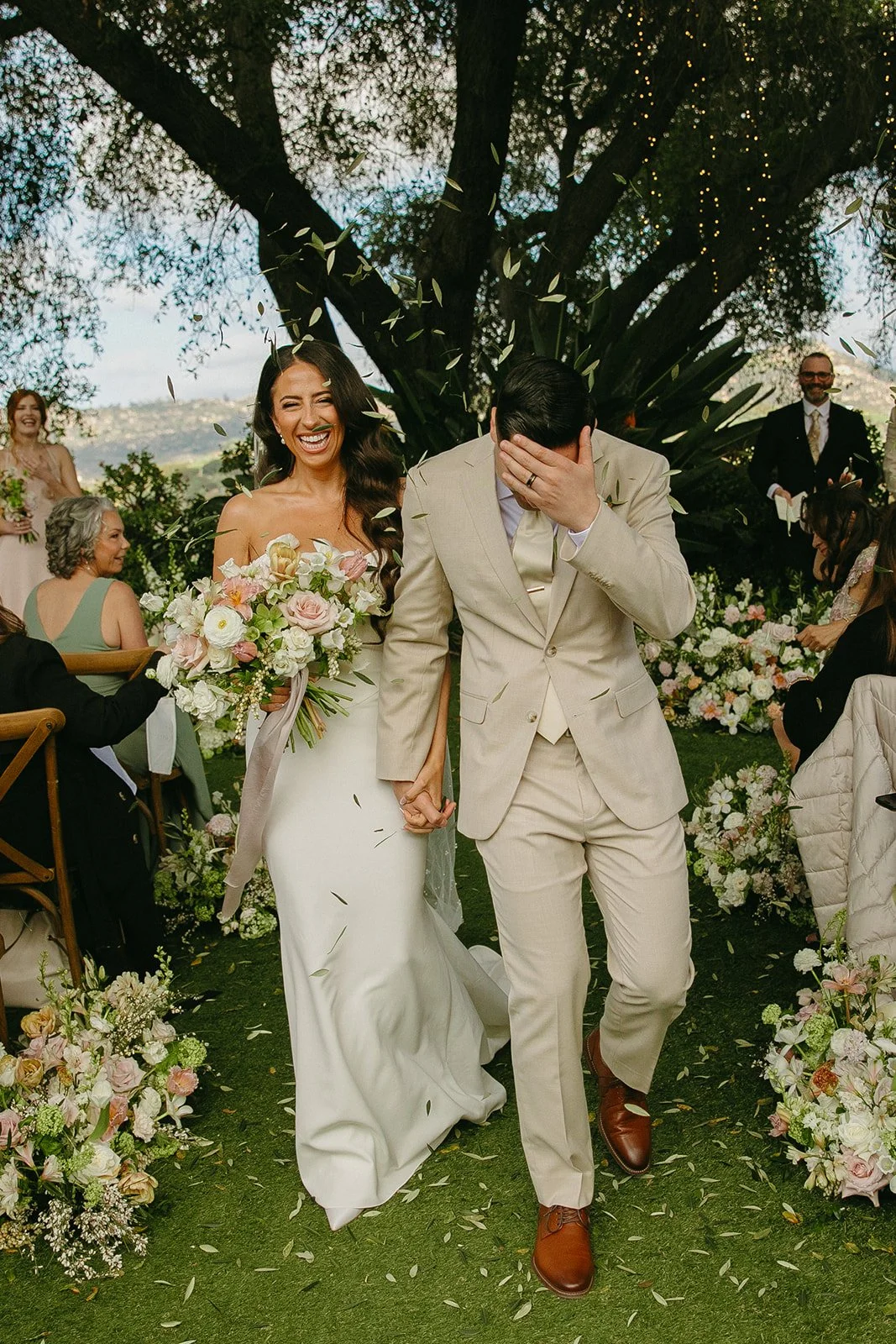 A bride and groom celebrating after their wedding ceremony