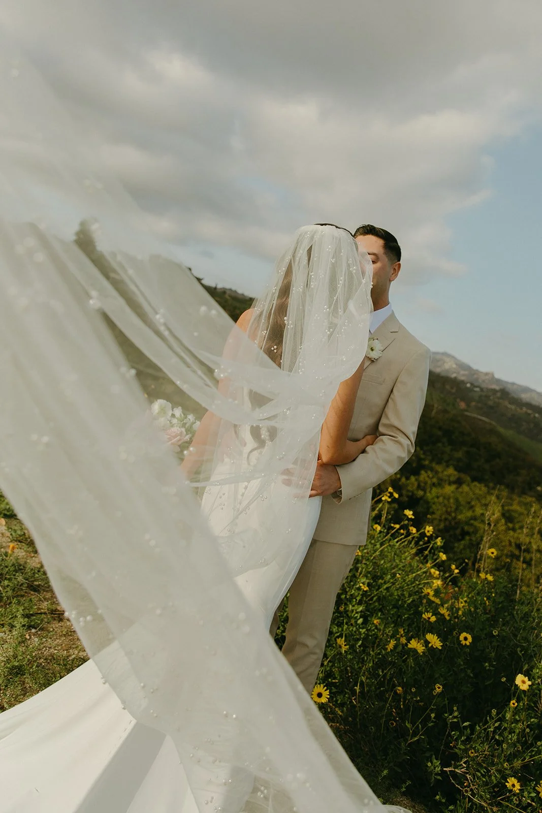 A bride and groom taking mountain wedding photos