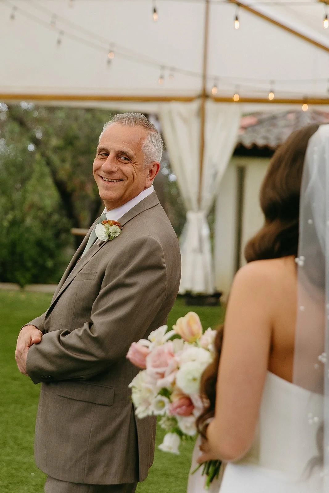 A bride and her dad sharing a first look