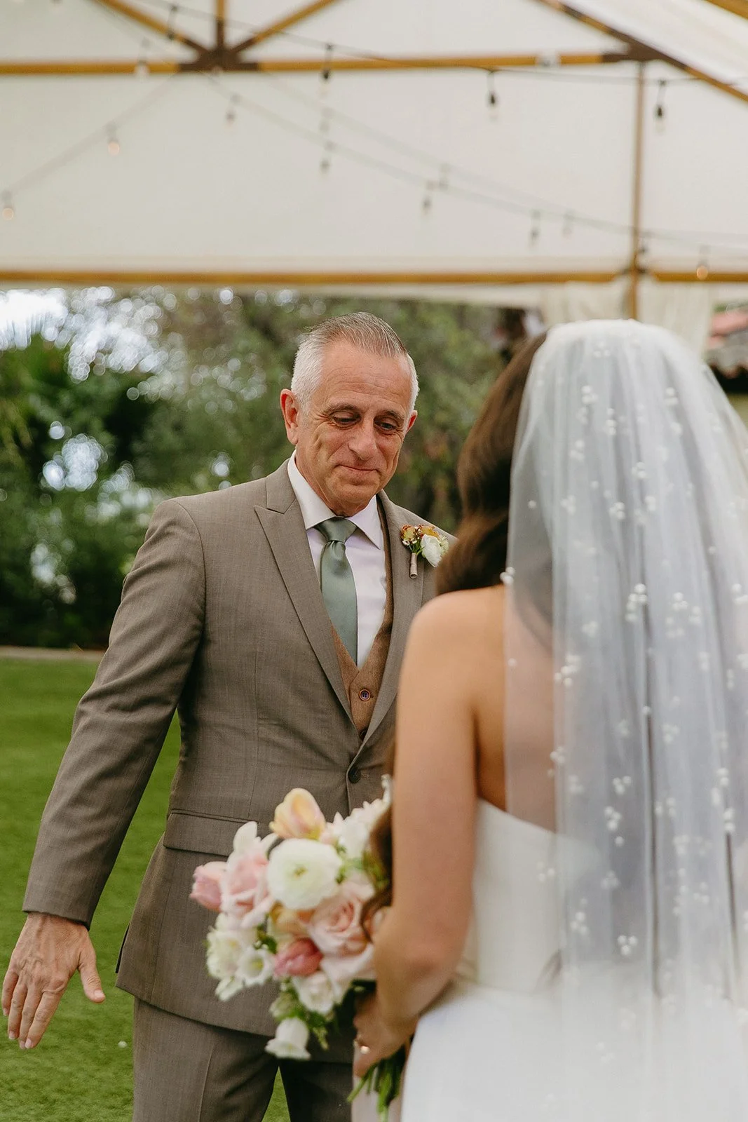 A bride and her dad sharing a first look