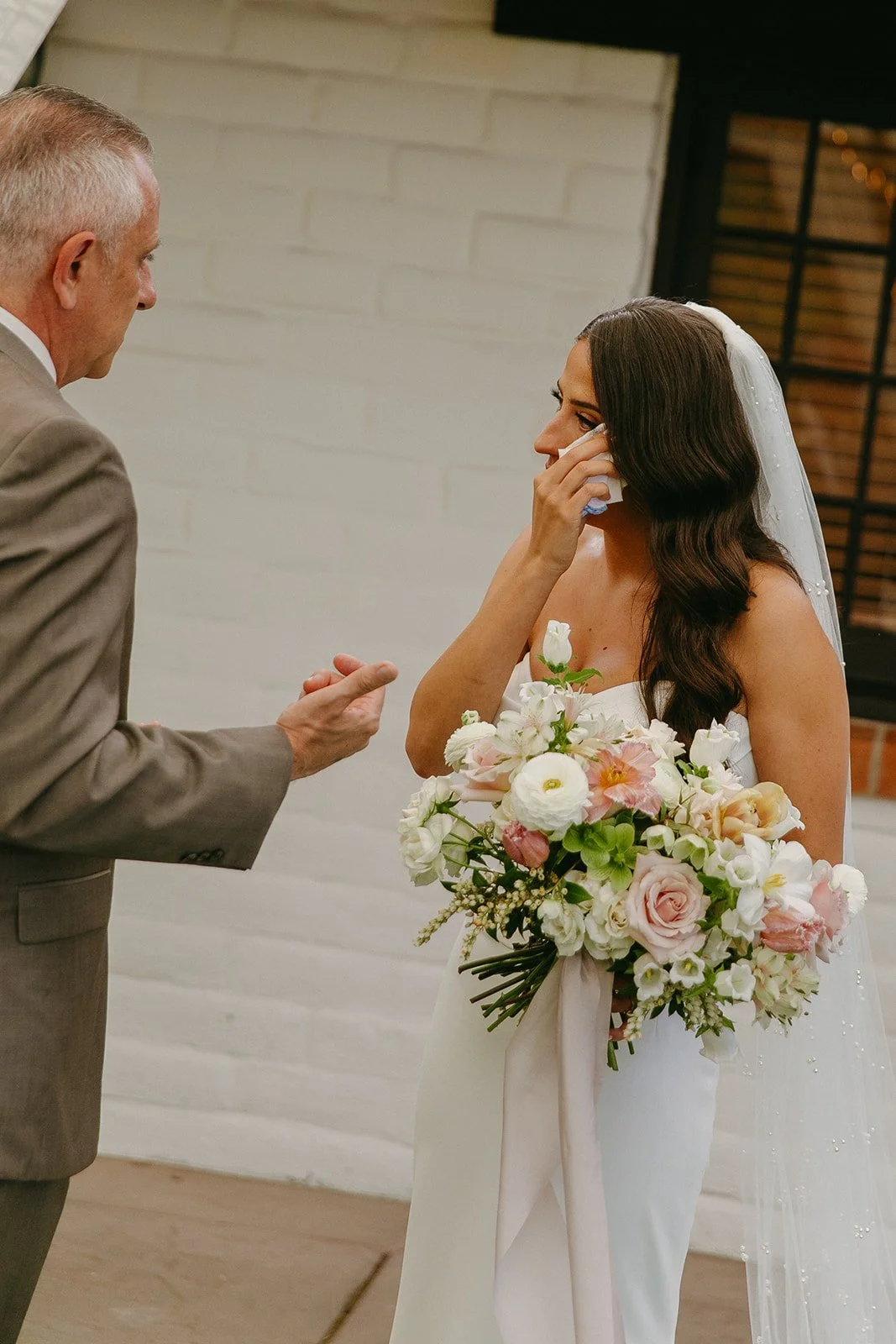 A bride and her dad sharing a first look