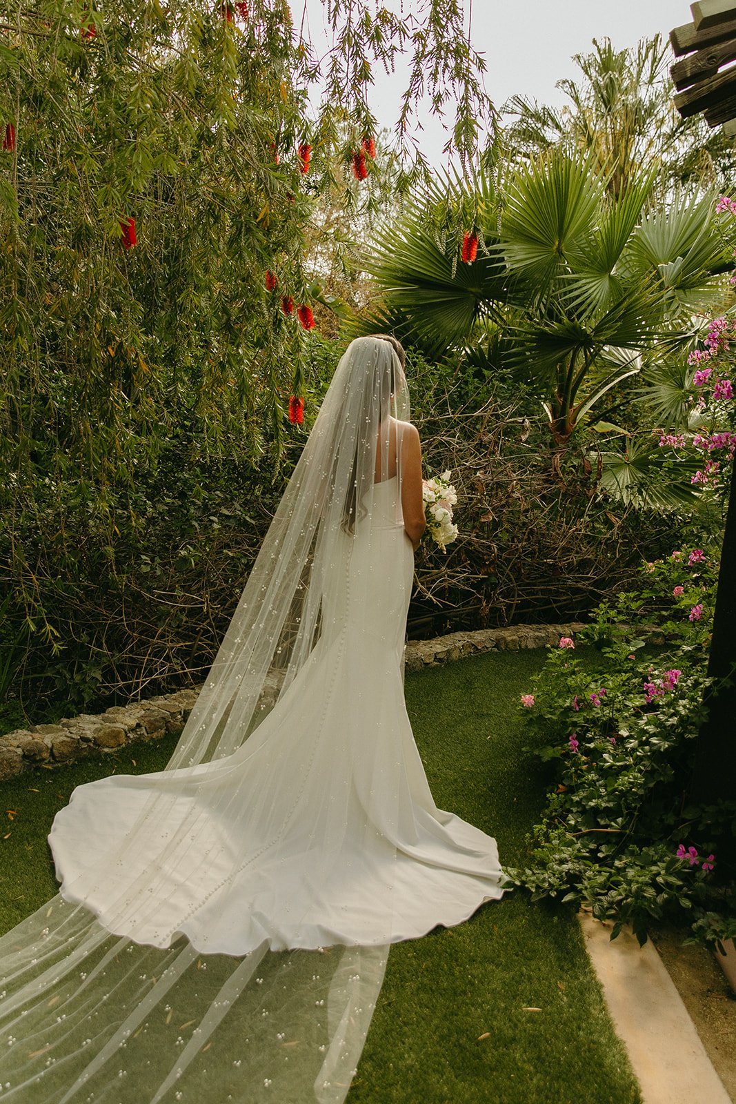 A bride taking bridal portraits at her outdoor wedding venue