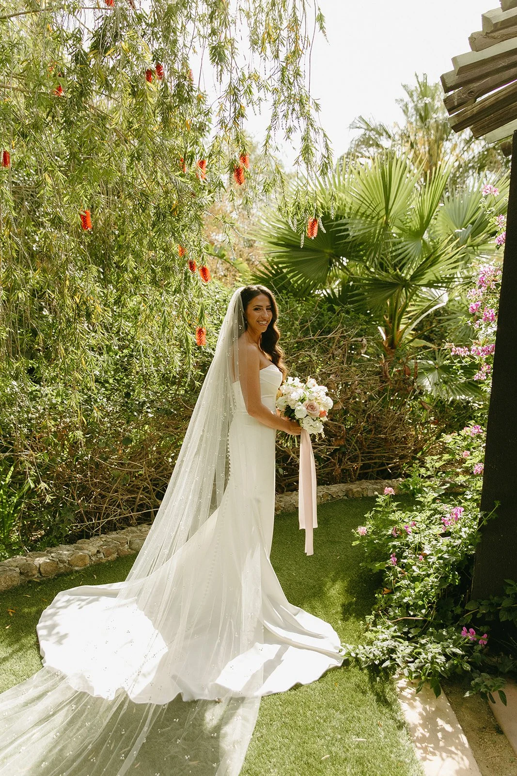 A bride taking bridal portraits at her outdoor wedding venue